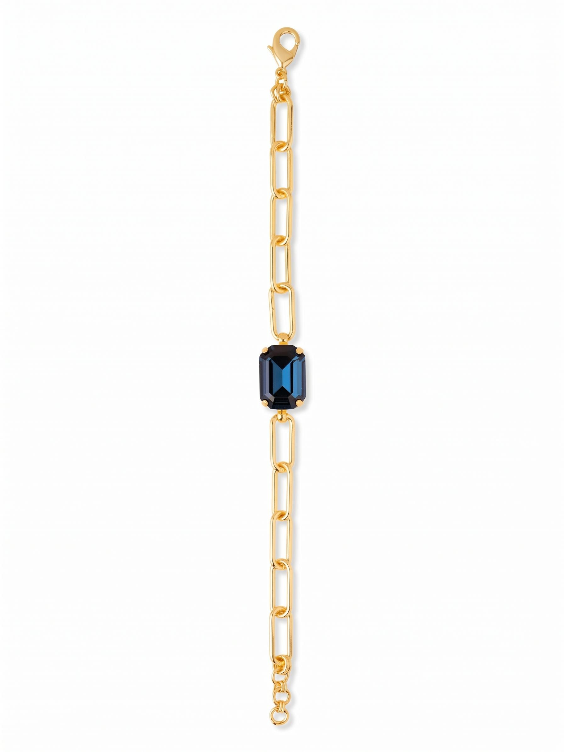 Brynn Paperclip Tennis Bracelet - BFS78BGMON - <p>A substantial emerald-cut crystal in deep Montana blue anchors this modern take on the everyday bracelet. The crisp facets of the central stone provide a sharp contrast to the airy, interlocking bright gold-tone paperclip chain. It brings a calculated geometry to your wrist, moving with a fluidity that feels right beside a favorite watch or layered with slender metal bangles. The open links keep the weight comfortable while maintaining a strong visual presence.</p><ul>
<li>Sharp contrast of an emerald-cut crystal against an airy open-link chain</li>
<li>Substantial central focal point framed by a modern geometric silhouette</li>
<li>Lobster claw clasp</li>
<li>3/4-inch adjustable extension chain</li>
<li>Protective e-coat finish for lasting wear</li>
<li>Includes signature organza pouch for gifting and travel</li>
</ul>