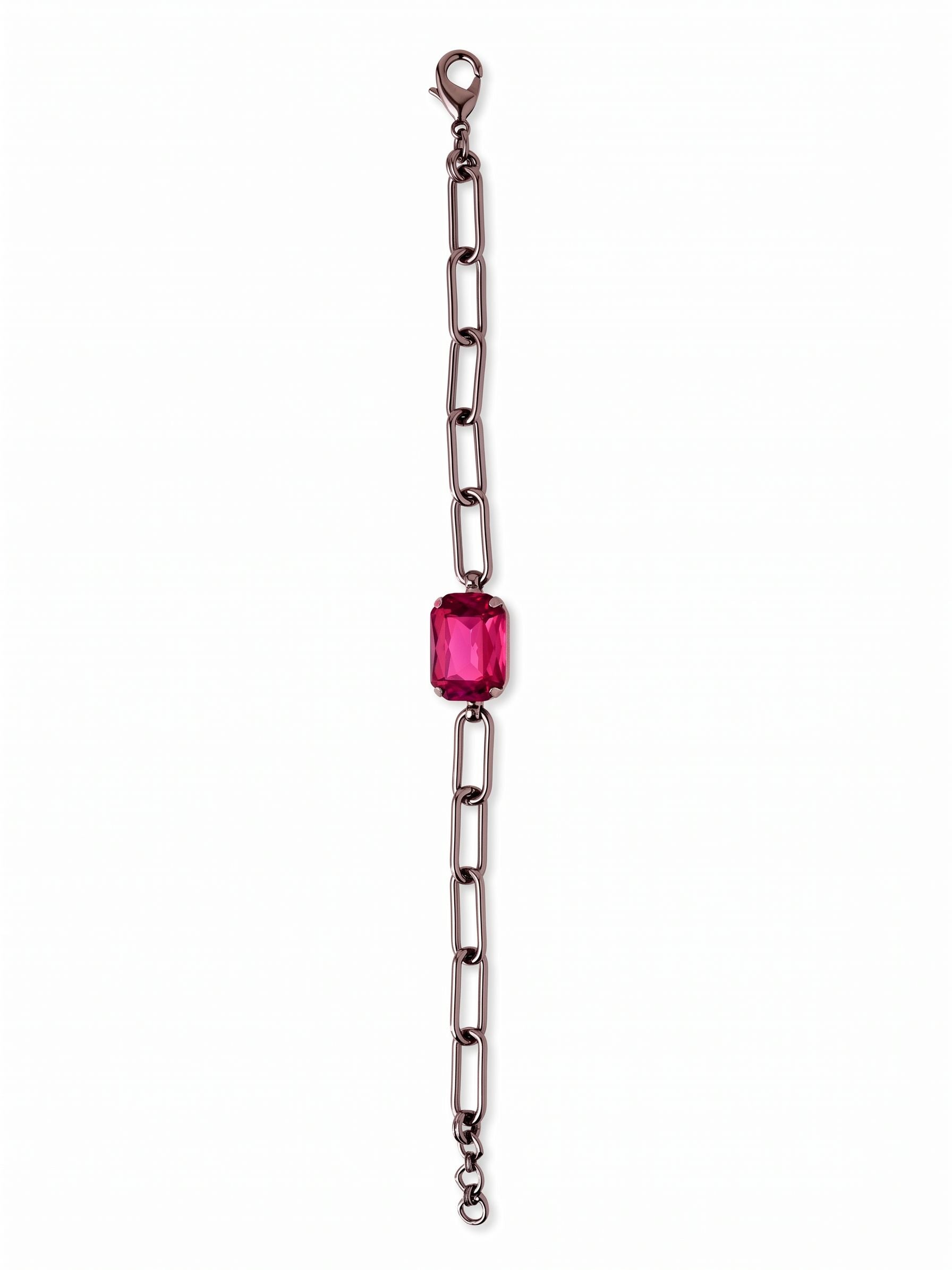 Brynn Paperclip Tennis Bracelet - BFS78GMFU - <p>A single emerald-cut fuchsia crystal anchors this open paperclip chain. The sharp contrast between the deep gunmetal links and the vibrant center stone creates a modern focal point that shifts naturally with your arm. Elongated metal links provide an airy, lightweight drape, while the solitary crystal offers just enough weight to keep the design balanced. It layers easily with delicate chains or holds its own as a clean, colorful accent.</p><ul>
<li>Oversized emerald-cut center stone anchors an airy design</li>
<li>Elongated paperclip links create an open, modern drape</li>
<li>Lobster claw clasp</li>
<li>3/4-inch adjustable extension chain</li>
<li>Includes organza pouch for gifting and travel</li>
</ul>