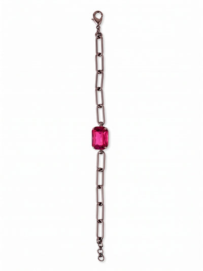 Brynn Paperclip Tennis Bracelet - BFS78GMFU - <p>A single emerald-cut fuchsia crystal anchors this open paperclip chain. The sharp contrast between the deep gunmetal links and the vibrant center stone creates a modern focal point that shifts naturally with your arm. Elongated metal links provide an airy, lightweight drape, while the solitary crystal offers just enough weight to keep the design balanced. It layers easily with delicate chains or holds its own as a clean, colorful accent.</p><ul>
<li>Oversized emerald-cut center stone anchors an airy design</li>
<li>Elongated paperclip links create an open, modern drape</li>
<li>Lobster claw clasp</li>
<li>3/4-inch adjustable extension chain</li>
<li>Includes organza pouch for gifting and travel</li>
</ul>