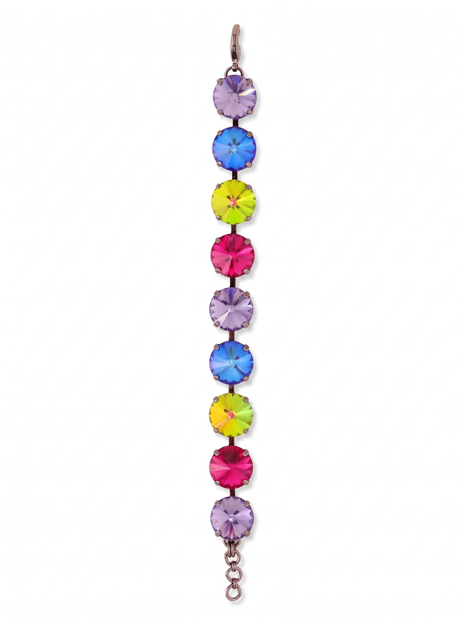 Nadine Tennis Bracelet - BFU3GMNNI - <p>Nine oversized round crystals form an unbroken line of saturated color around the wrist. The dark gunmetal setting provides deep contrast, making the progression of fuchsia, tanzanite, and color-shifting stones catch the light with every movement. Built on a flexible kette chain, the articulated links move fluidly with you throughout the day. An extension chain lets you adjust the drape, whether you prefer a close fit or want the piece to drop slightly over the hand.</p><ul>
<li>Nine oversized round crystals in a high-contrast linear sequence</li>
<li>Articulated kette chain construction allows fluid movement on the arm</li>
<li>Lobster claw clasp</li>
<li>3/4-inch adjustable extension chain</li>
<li>Includes signature organza pouch for gifting and travel</li>
</ul>