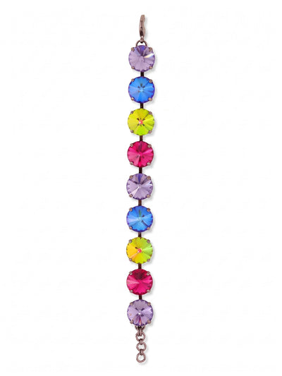 Nadine Tennis Bracelet - BFU3GMNNI - <p>Nine oversized round crystals form an unbroken line of saturated color around the wrist. The dark gunmetal setting provides deep contrast, making the progression of fuchsia, tanzanite, and color-shifting stones catch the light with every movement. Built on a flexible kette chain, the articulated links move fluidly with you throughout the day. An extension chain lets you adjust the drape, whether you prefer a close fit or want the piece to drop slightly over the hand.</p><ul>
<li>Nine oversized round crystals in a high-contrast linear sequence</li>
<li>Articulated kette chain construction allows fluid movement on the arm</li>
<li>Lobster claw clasp</li>
<li>3/4-inch adjustable extension chain</li>
<li>Includes signature organza pouch for gifting and travel</li>
</ul>