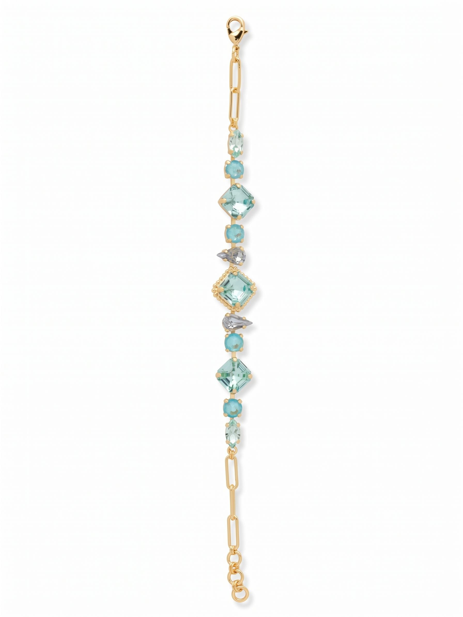 Izzy Tennis Bracelet - BFY40BGOC - <p>This reimagined tennis bracelet balances the clean lines of open paperclip links with a rhythmic arrangement of fancy-cut crystals. Square, pear, and marquise stones in varied shades of blue catch the light with every movement of your hand. The central aquamarine crystal is framed by a subtle ball chain halo, adding quiet architectural detail. The open design keeps the overall silhouette fluid and light, while the adjustable extension ensures a secure fit alongside your everyday watch or favorite stacking pieces.</p><ul>
<li>Open paperclip chain links contrast with an intricate center of mixed fancy-cut crystals</li>
<li>Focal square crystal framed by a subtle textured ball chain halo</li>
<li>Lobster claw clasp</li>
<li>3/4-inch adjustable extension chain</li>
<li>Protective e-coat finish for lasting wear</li>
<li>Includes signature organza pouch for gifting and travel</li>
</ul>