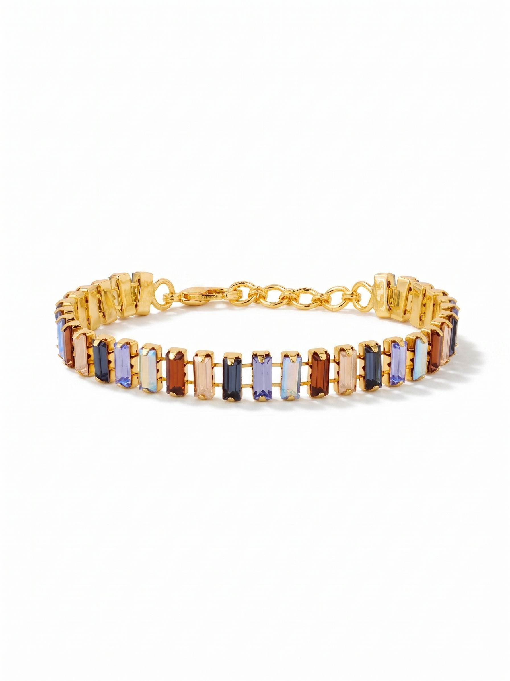 Bianca Tennis Bracelet - BFY55BGDNM - <p>A structured line of vertical baguette crystals builds the foundation of this tennis bracelet. Deep sapphires and pale iridescent blues meet smoked topaz and golden shadow stones, creating a rich contrast of cool hues and warm earth tones. The articulated channel chain allows the geometric stones to flex with your natural movement, forming an unbroken rhythm around the arm. An adjustable clasp provides a tailored fit that remains comfortable from morning into evening.</p><ul>
<li>Vertical baguette crystals arranged in a repeating geometric rhythm</li>
<li>Articulated channel chain allows the structured stones to flex naturally</li>
<li>Lobster claw clasp</li>
<li>3/4-inch adjustable extension chain</li>
<li>Protective e-coat finish for lasting wear</li>
<li>Includes signature organza pouch for gifting and travel</li>
</ul>