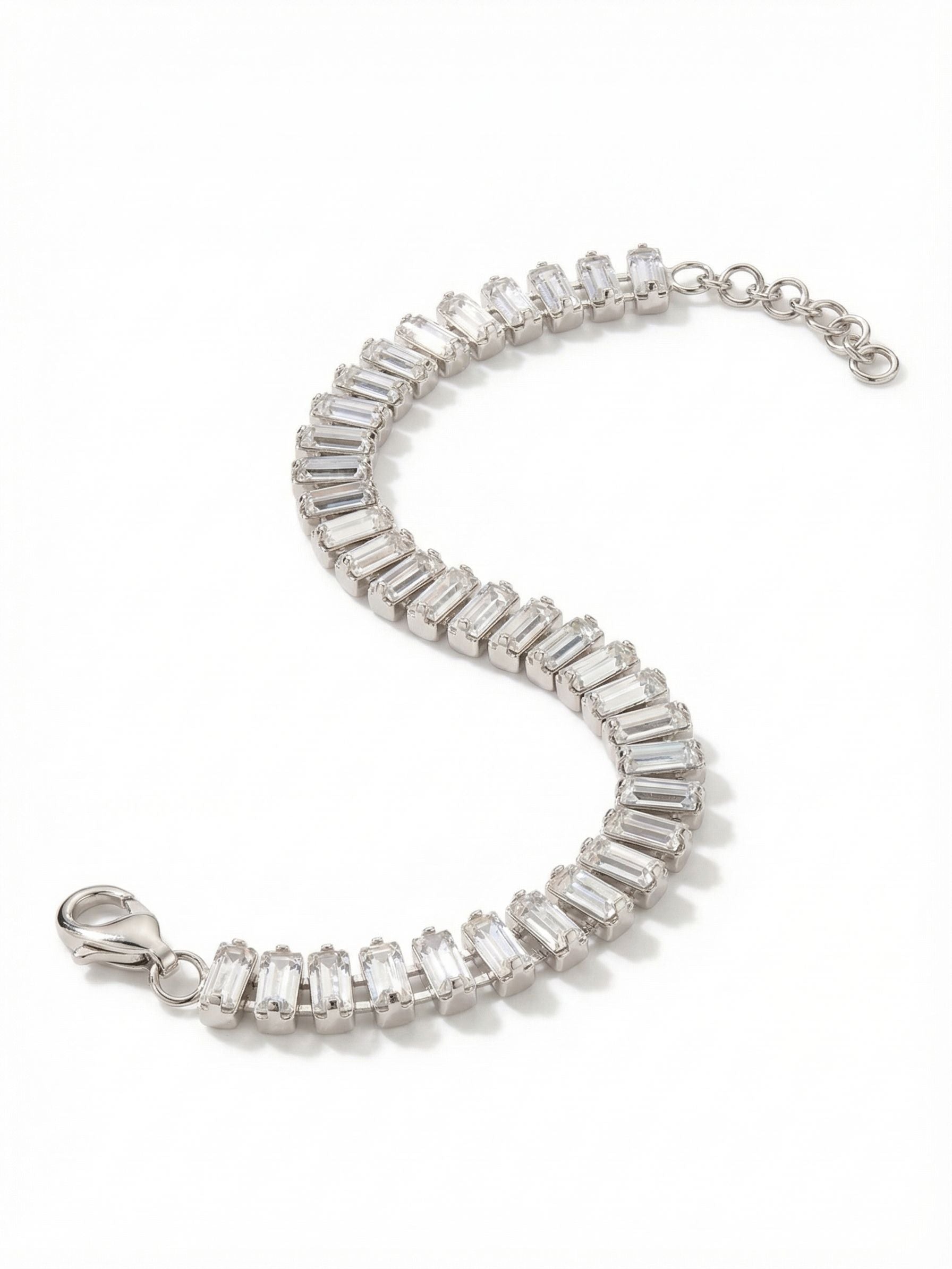 Bianca Tennis Bracelet - BFY55PDCRY - <p>Baguette-cut clear crystals form a continuous, tailored line that brings structured architecture to your wrist. The flexible kette chain construction allows each geometric stone to articulate independently, creating a fluid drape that moves naturally with your hand. Adjust the fit exactly to your preference using the included extension chain. This piece offers a crisp, defined presence that works just as well grounding a stack of varied bracelets as it does worn entirely on its own.</p><ul>
<li>Continuous row of geometric baguette-cut crystals</li>
<li>Flexible kette chain construction for a fluid drape</li>
<li>Lobster claw clasp</li>
<li>3/4-inch adjustable extension chain</li>
<li>Protective e-coat finish for lasting wear</li>
<li>Includes signature organza pouch for gifting and travel</li>
</ul>