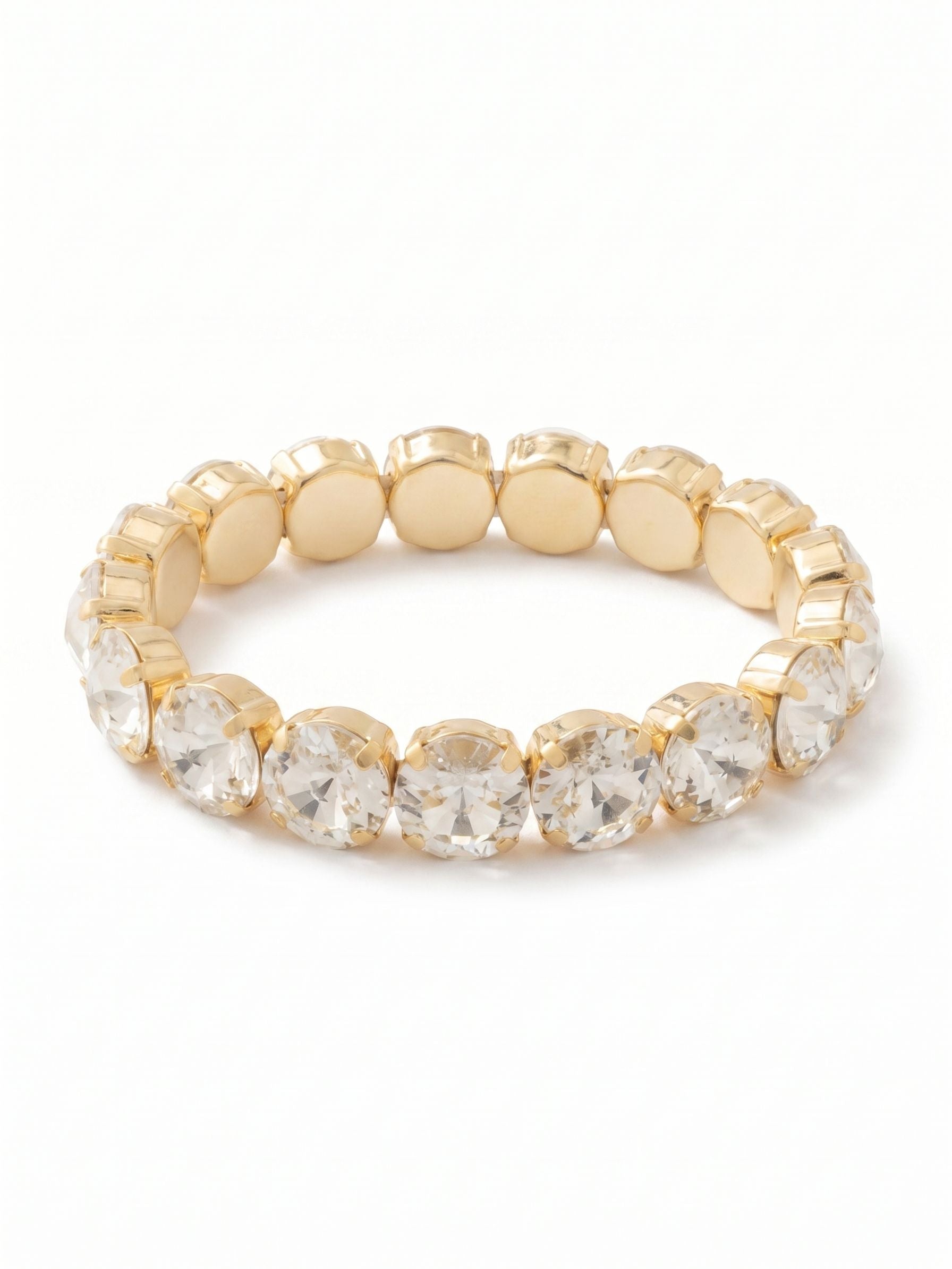 London Stretch Bracelet - BFY8BGCRY - <p>Seventeen large, round-cut clear crystals form an unbroken line of light around the arm. The half-inch scale gives this piece substantial weight and presence, while the stones draw warmth from their gold-tone settings. Designed to slip effortlessly over the hand, the flexible construction adapts to your movement throughout the day. It layers naturally with your daily watch but commands enough attention to wear entirely on its own.</p><ul>
<li>Continuous band of oversized round-cut crystals</li>
<li>Flexible base rolls over the hand without hardware</li>
<li>Stretch easy slip-on design</li>
<li>Protective e-coat finish for lasting wear</li>
<li>Includes signature organza pouch for gifting and travel</li>
</ul>