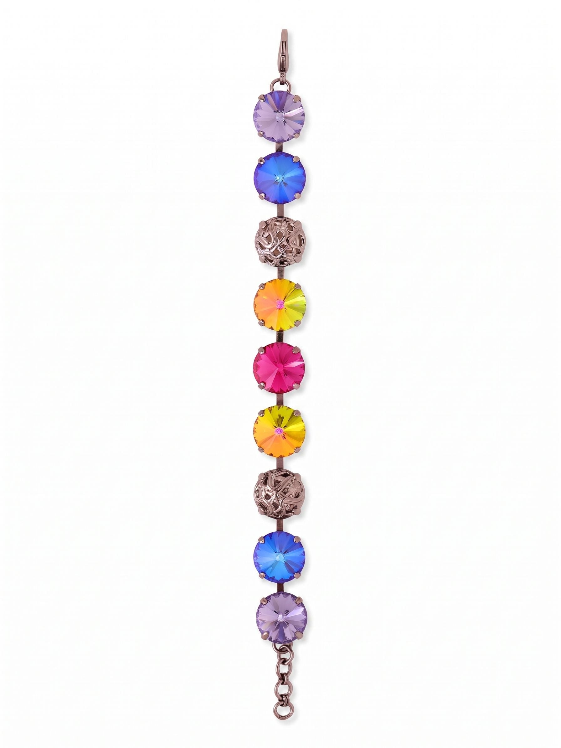 Clementine Tennis Bracelet - BFZ180GMNNI - <p>Vibrant round-cut crystals alternate with intricate openwork metal spheres along a flexible chain. The striking contrast of brilliant fuchsia, fiery volcano orange, and cool tanzanite against the dark gunmetal finish creates a vivid presence on the wrist. Built on a fluid kette construction, the design moves naturally with you rather than feeling stiff or rigid. An extension chain lets you adjust the drape to your exact preference, whether you wear it completely solo or layered into an active daily stack.</p><ul>
<li>Oversized round crystals interspersed with textural metalwork for a varied visual rhythm</li>
<li>Fluid kette chain construction ensures flexible movement and comfortable daily wear</li>
<li>Lobster claw clasp</li>
<li>3/4-inch adjustable extension chain</li>
<li>Includes signature organza pouch for gifting and travel</li>
</ul>