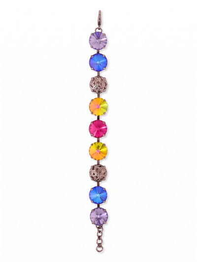 Clementine Tennis Bracelet - BFZ180GMNNI - <p>Vibrant round-cut crystals alternate with intricate openwork metal spheres along a flexible chain. The striking contrast of brilliant fuchsia, fiery volcano orange, and cool tanzanite against the dark gunmetal finish creates a vivid presence on the wrist. Built on a fluid kette construction, the design moves naturally with you rather than feeling stiff or rigid. An extension chain lets you adjust the drape to your exact preference, whether you wear it completely solo or layered into an active daily stack.</p><ul>
<li>Oversized round crystals interspersed with textural metalwork for a varied visual rhythm</li>
<li>Fluid kette chain construction ensures flexible movement and comfortable daily wear</li>
<li>Lobster claw clasp</li>
<li>3/4-inch adjustable extension chain</li>
<li>Includes signature organza pouch for gifting and travel</li>
</ul>