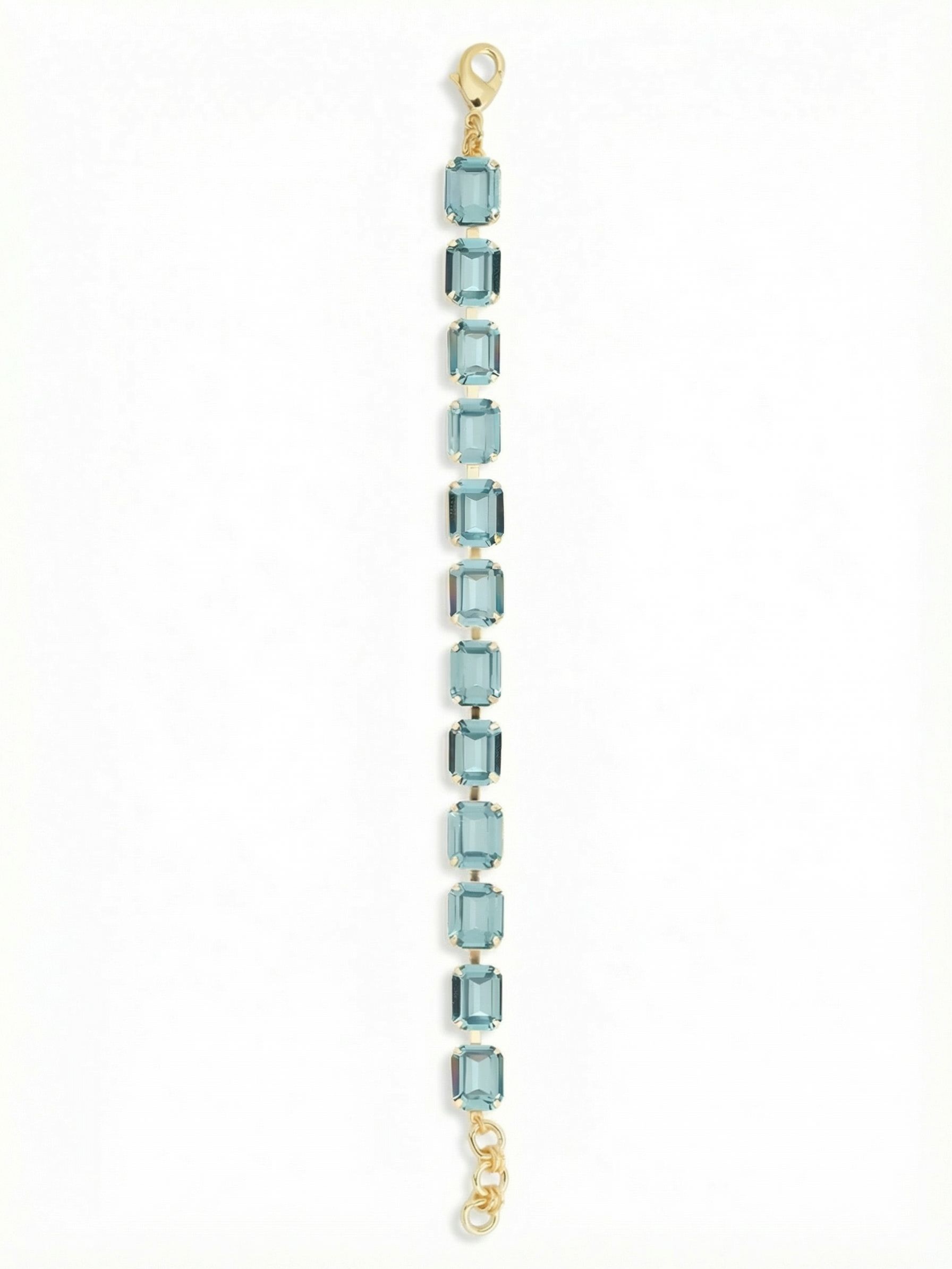 Octavia Repeating Tennis Bracelet - BFZ6BGAQU - <p>Twelve emerald-cut aquamarine crystals form a refined, architectural take on the classic tennis silhouette. The step-cut faceting catches light in deep, linear flashes as your hand moves, offering a clean alternative to traditional round stones. Built on a flexible channel chain, the piece drapes effortlessly and moves naturally with you. It carries enough presence to wear alone, yet comfortably anchors a heavier gold stack. An included extension chain lets you adjust the drape to your exact preference.</p><ul>
<li>Emerald-cut stones provide an architectural alternative to traditional round tennis designs</li>
<li>Flexible channel chain construction ensures the continuous crystal line moves fluidly</li>
<li>Lobster claw clasp</li>
<li>3/4-inch adjustable extension chain</li>
<li>Protective e-coat finish for lasting wear</li>
<li>Includes signature organza pouch for gifting and travel</li>
</ul>
