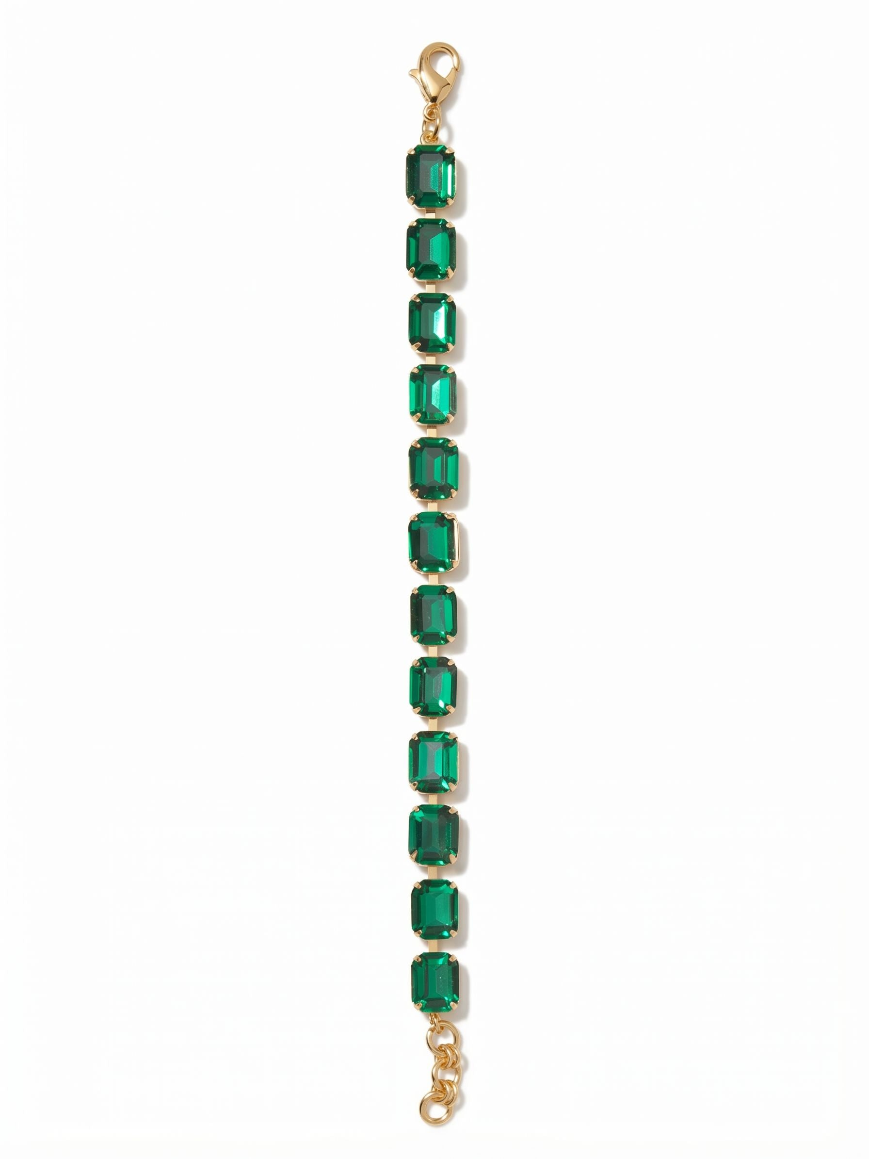 Octavia Repeating Tennis Bracelet - BFZ6BGEME - <p>Deep green emerald-cut crystals encircle the wrist in an unbroken rhythm, casting long, structured flashes of light with every movement. Built on a flexible channel chain, this bracelet offers substantial weight and a fluid drape that moves naturally with you throughout the day. The bold scale gives it enough presence to stand alone effortlessly, while the extension chain allows you to secure the exact right fit.</p><ul>
<li>Deep step-cut facets create structured flashes of light rather than scattered sparkle</li>
<li>Fluid channel chain construction allows the crystals to articulate naturally with movement</li>
<li>Lobster claw clasp</li>
<li>3/4-inch adjustable extension chain</li>
<li>Protective e-coat finish for lasting wear</li>
<li>Includes signature organza pouch for gifting and travel</li>
</ul>