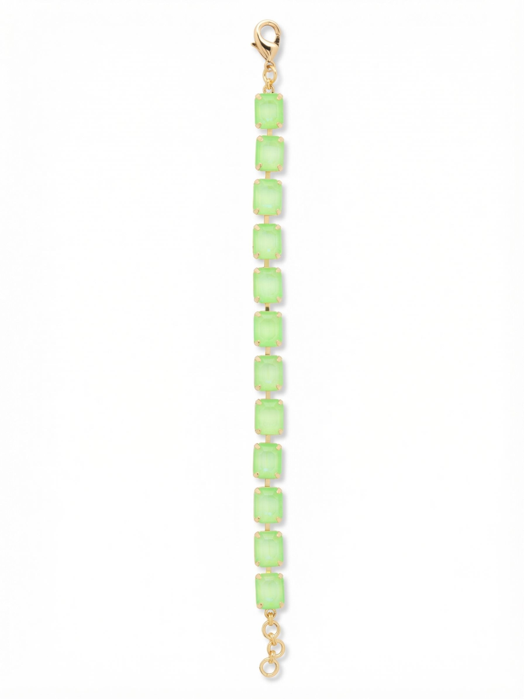 Octavia Repeating Tennis Bracelet - BFZ6BGETG - <p>A steady rhythm of emerald-cut crystals delivers a bright wash of color that shifts with every motion of your arm. The step cuts reflect light in broad, deliberate flashes rather than a scattered sparkle. Built on a flexible channel chain, the line moves organically as you go about your day without feeling rigid. An included extension chain lets you dial in the exact fit so you can place it perfectly within your favorite stack.</p><ul>
<li>Continuous sequence of electric green emerald-cut crystals</li>
<li>Fluid channel chain construction that bends easily with movement</li>
<li>Lobster claw clasp</li>
<li>3/4-inch adjustable extension chain</li>
<li>Protective e-coat finish for lasting wear</li>
<li>Includes signature organza pouch for gifting and travel</li>
</ul>