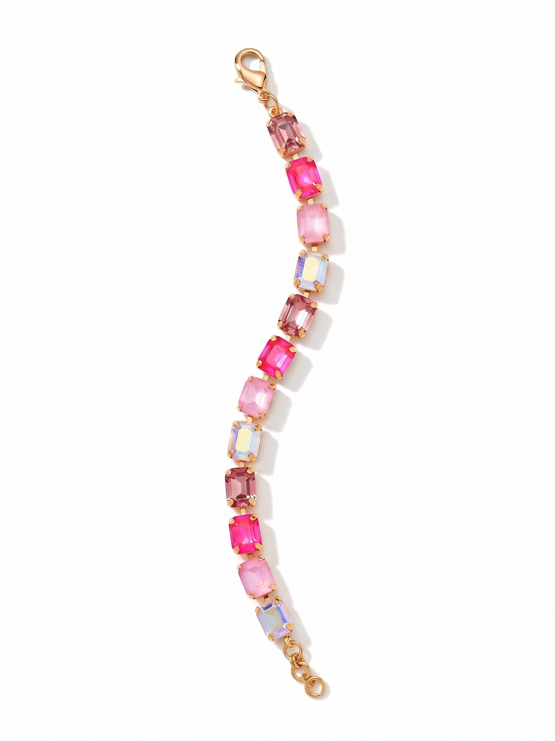 Octavia Repeating Tennis Bracelet - BFZ6BGPIN - <p>Large emerald-cut crystals in shifting shades of pink form a fluid line of structured light. Set in a flexible channel chain, the stones move easily with your arm, offering the substantial weight of a classic tennis bracelet with a distinctly modern geometry. The bright gold-tone setting highlights a repeating sequence from pale rose to vibrant electric pink. An extension chain lets you tailor the drape, whether worn closely or layered loosely with other pieces.</p><ul>
<li>Repeating sequence of distinct pink and iridescent shades</li>
<li>Fluid channel chain construction for articulated movement</li>
<li>Lobster claw clasp</li>
<li>3/4-inch adjustable extension chain</li>
<li>Protective e-coat finish for lasting wear</li>
<li>Includes organza pouch for gifting and travel</li>
</ul>