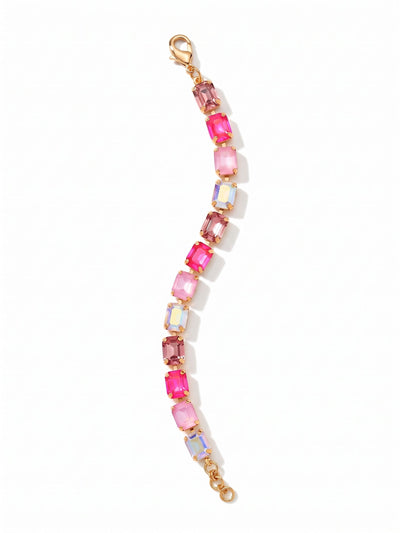 Octavia Repeating Tennis Bracelet - BFZ6BGPIN - <p>Large emerald-cut crystals in shifting shades of pink form a fluid line of structured light. Set in a flexible channel chain, the stones move easily with your arm, offering the substantial weight of a classic tennis bracelet with a distinctly modern geometry. The bright gold-tone setting highlights a repeating sequence from pale rose to vibrant electric pink. An extension chain lets you tailor the drape, whether worn closely or layered loosely with other pieces.</p><ul>
<li>Repeating sequence of distinct pink and iridescent shades</li>
<li>Fluid channel chain construction for articulated movement</li>
<li>Lobster claw clasp</li>
<li>3/4-inch adjustable extension chain</li>
<li>Protective e-coat finish for lasting wear</li>
<li>Includes organza pouch for gifting and travel</li>
</ul>