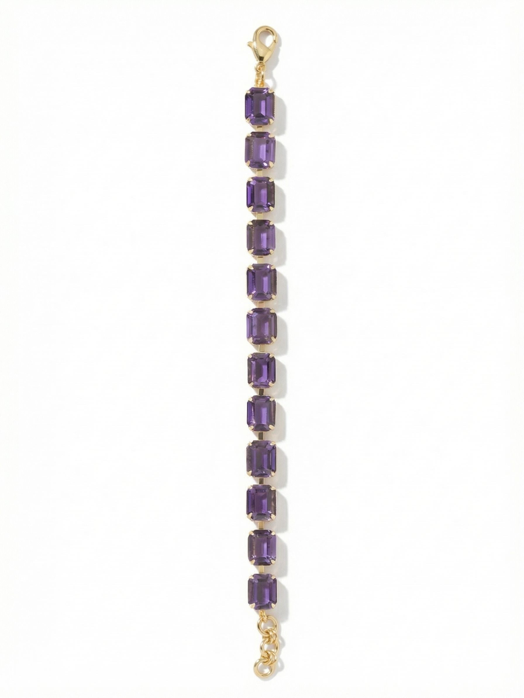 Octavia Repeating Tennis Bracelet - BFZ6BGPV - <p>Deep, velvety purple crystals cut in sharp emerald shapes create a continuous band of light and structure. The articulated channel chain gives the piece a satisfying, substantial weight while allowing the rectangular stones to flex naturally with your movement. Whether anchored alone or layered into a daily stack, the built-in extension chain ensures the drape feels exactly right on your arm.</p><ul>
<li>Bold emerald-cut crystals offer architectural depth</li>
<li>Articulated channel chain provides continuous fluid movement</li>
<li>Lobster claw clasp</li>
<li>3/4-inch adjustable extension chain</li>
<li>Protective e-coat finish for lasting wear</li>
<li>Includes signature organza pouch for gifting and travel</li>
</ul>