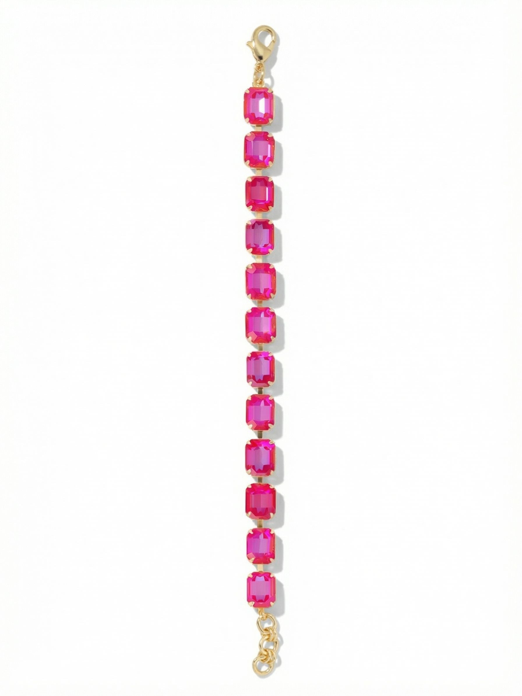 Octavia Repeating Tennis Bracelet - BFZ6BGRRD - <p>A solid streak of intense color wraps the arm in a continuous line. The Octavia connects twelve substantial emerald-cut crystals in a fluid channel chain, creating a ribbon of light that moves with every gesture. The bright gold-tone setting offers a warm, structured frame for the vibrant red stones. Finished with an extension chain to dial in the perfect drape, this confident piece easily anchors a daily bracelet stack or brings focused energy to a bare wrist.</p><ul>
<li>Substantial emerald-cut crystals create a bold geometric line</li>
<li>Fluid channel chain construction allows for continuous movement</li>
<li>Lobster claw clasp</li>
<li>3/4-inch adjustable extension chain</li>
<li>Protective e-coat finish for lasting wear</li>
<li>Includes signature organza pouch for gifting and travel</li>
</ul>