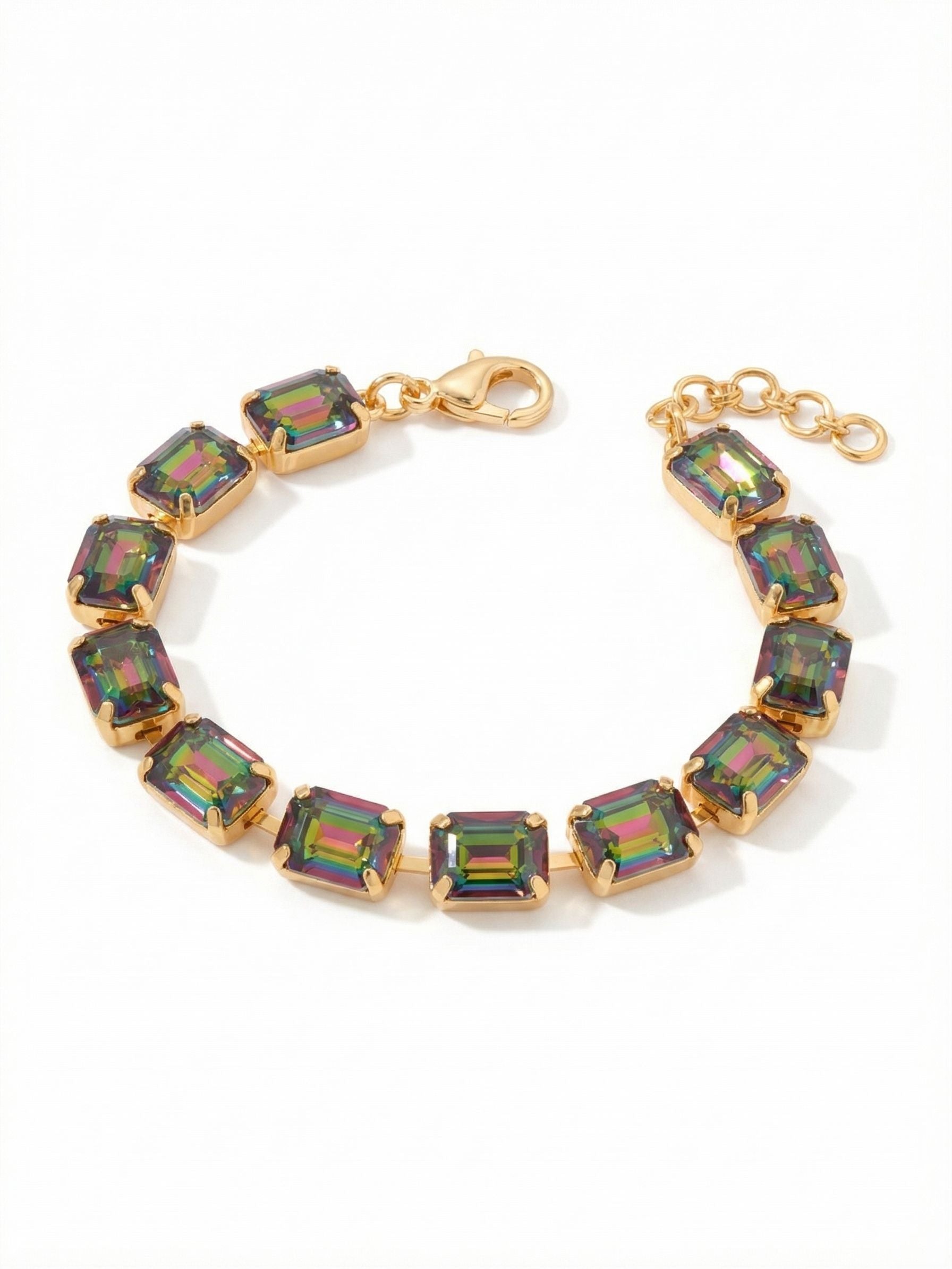 Octavia Repeating Tennis Bracelet - BFZ6BGVO - <p>A continuous line of substantial emerald-cut crystals wraps the arm in shifting hues of deep purple and vibrant green. The flexible channel-set construction allows the bracelet to articulate easily, creating a fluid drape that moves naturally with your hand. Bright gold-tone settings frame the crisp geometric lines of each stone. It brings focused color to your daily rotation and includes an extension chain to secure your preferred fit.</p><ul>
<li>Unbroken sequence of emerald-cut crystals</li>
<li>Flexible channel setting for fluid articulation</li>
<li>Lobster claw clasp</li>
<li>3/4-inch adjustable extension chain</li>
<li>Protective e-coat finish for lasting wear</li>
<li>Includes signature organza pouch for gifting and travel</li>
</ul>
