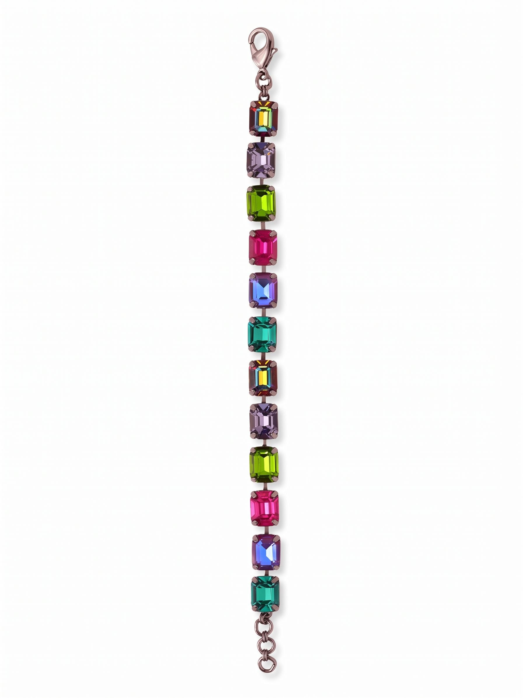 Octavia Repeating Tennis Bracelet - BFZ6GMNNI - <p>Deep, saturated color takes on a structured edge in this vibrant tennis bracelet. Twelve substantial emerald-cut crystals create a bold sequence of rich tones, moving from vivid fuchsia to deep tanzanite and olivene. The flexible kette chain construction allows the piece to articulate fluidly as your hand moves, letting the broad geometric facets catch the light in wide flashes. Finished with an extension chain, you can adjust the drape to your exact preference.</p><ul>
<li>Substantial emerald-cut crystals offer a bold geometric profile</li>
<li>Flexible chain construction allows natural articulation with movement</li>
<li>Lobster claw clasp</li>
<li>3/4-inch adjustable extension chain</li>
<li>Includes signature organza pouch for gifting and travel</li>
</ul>