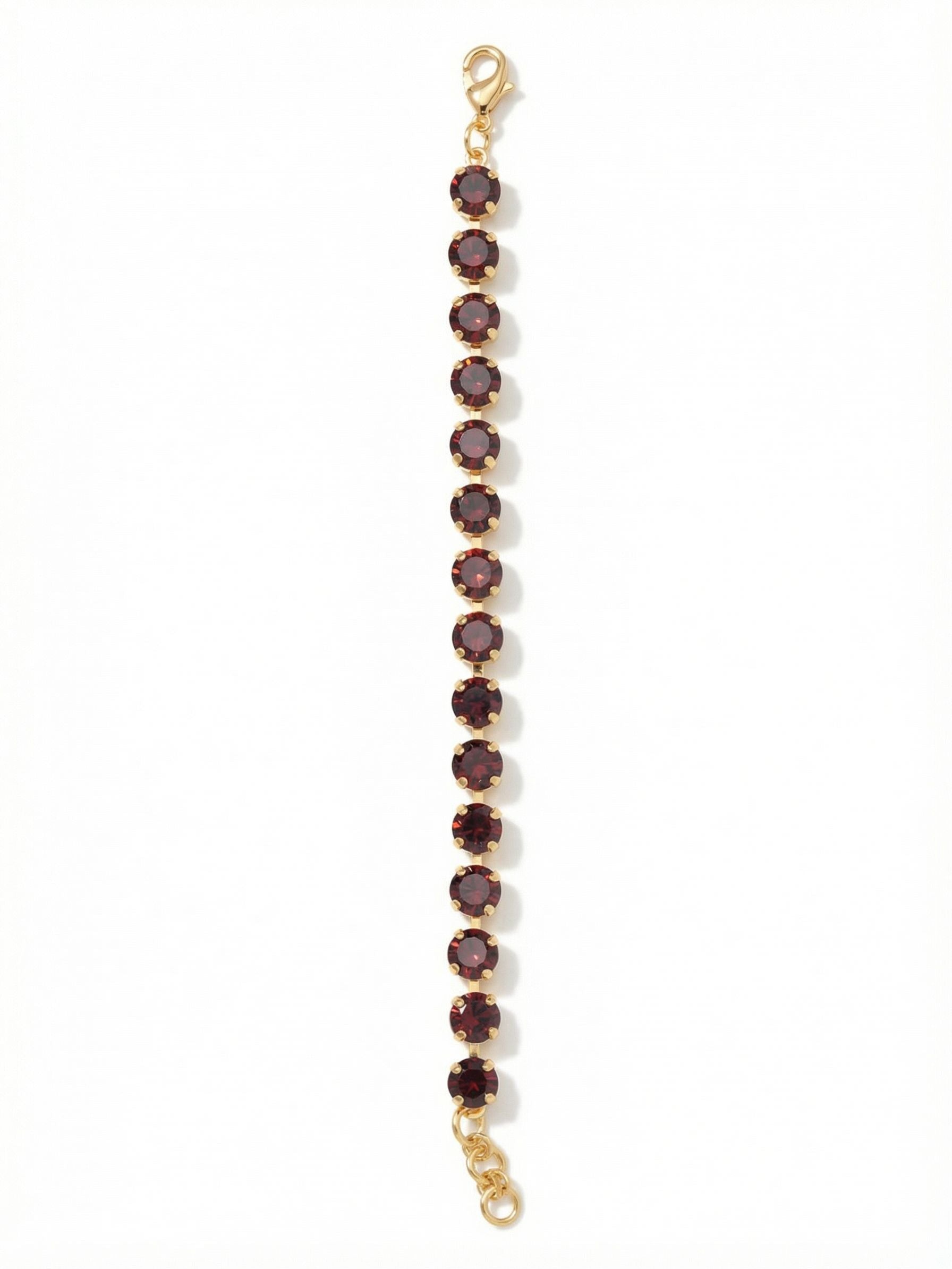 Sienna Tennis Bracelet - BGA2BGBUR - <p>A continuous line of deep burgundy crystals creates a rich band of color that moves effortlessly with your hand. The round-cut stones catch ambient light with every gesture, bringing quiet depth to the gold-tone setting. Built on a fluid channel chain, the bracelet flexes naturally as you go about your day. An adjustable extension chain lets you find the exact drape that feels right, whether worn as a solo signature piece or layered into your daily stack.</p><ul>
<li>Continuous row of uniform round-cut crystals</li>
<li>Flexible channel chain construction</li>
<li>Lobster claw clasp</li>
<li>3/4-inch adjustable extension chain</li>
<li>Protective e-coat finish for lasting wear</li>
<li>Includes signature organza pouch for gifting and travel</li>
</ul>