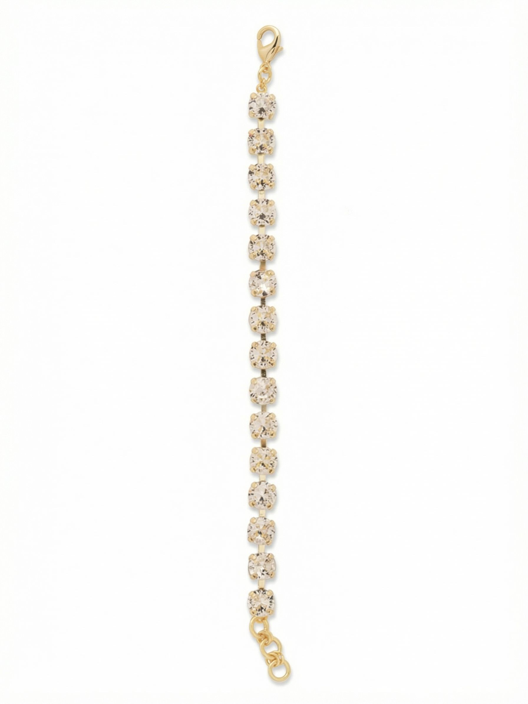 Sienna Tennis Bracelet - BGA2BGCRY - <p>The Sienna Tennis Bracelet offers a continuous stream of light that moves with your every gesture. Fifteen substantial round-cut clear crystals are linked in a classic channel construction, allowing the piece to drape easily over the hand and shift naturally as you move. It carries a satisfying weight that anchors a stacked wrist or stands strong when worn solo. An integrated extension chain lets you find your exact preferred fit for all-day wear.</p><ul>
<li>Substantial round-cut crystals set in a fluid channel construction</li>
<li>Unbroken line design that shifts and catches light in motion</li>
<li>Lobster claw clasp</li>
<li>3/4-inch adjustable extension chain</li>
<li>Protective e-coat finish for lasting wear</li>
<li>Includes signature organza pouch for gifting and travel</li>
</ul>