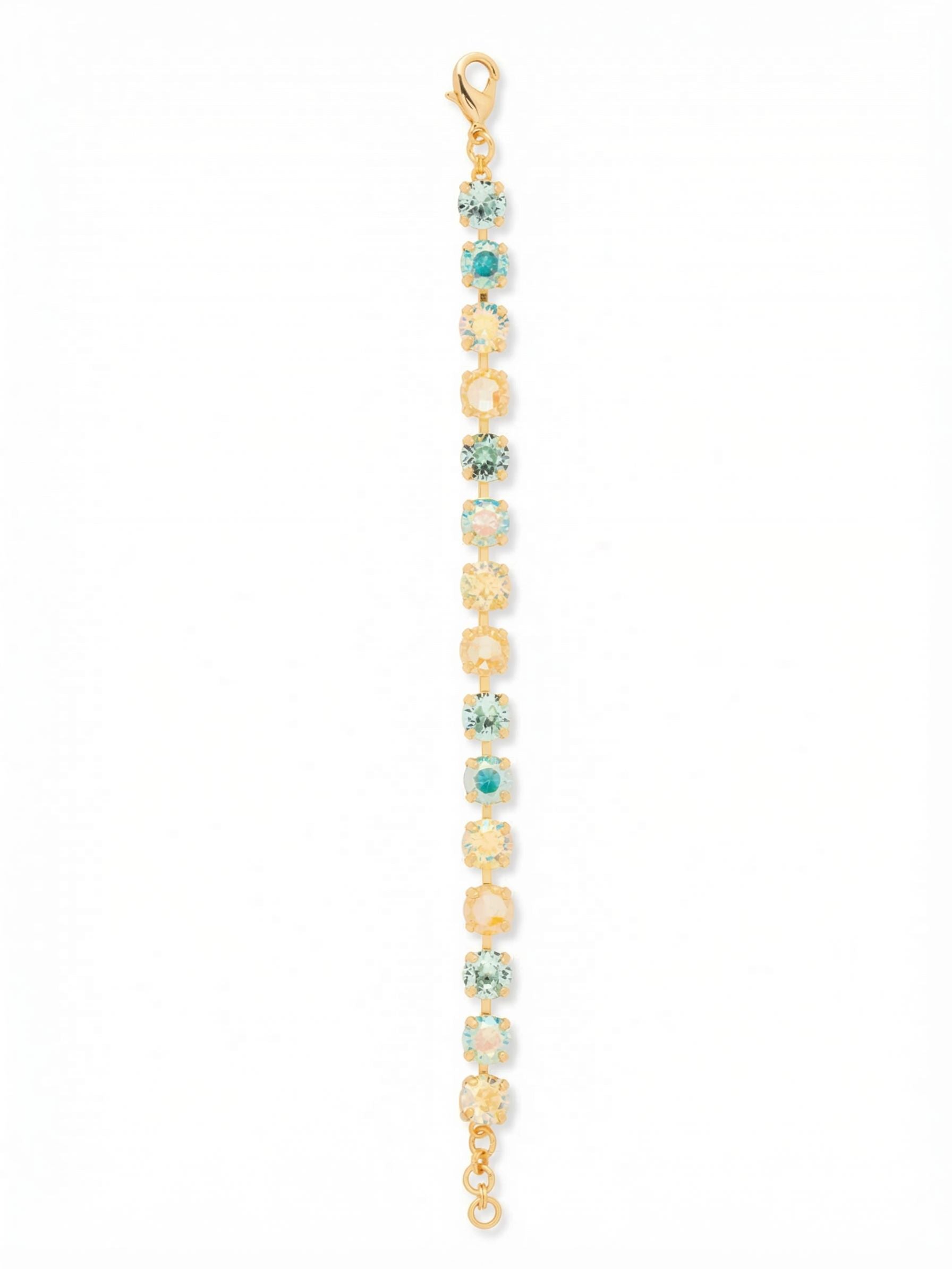 Sienna Tennis Bracelet - BGA2BGCSD - <p>Warm gold grounds a fluid line of pale aquamarine and sunlit yellow crystals in the Sienna Tennis Bracelet. The articulated chain flexes naturally as your hand moves, catching every shift in light through the soft Aurora Borealis finishes. Designed with an extension chain to let you find your preferred drape, this piece brings a quiet wash of coastal color to your daily stack. The continuous sequence of round stones delivers an unbroken ribbon of light.</p><ul>
<li>Alternating sequence of warm topaz and cool aquamarine stones creates a rhythmic color pattern</li>
<li>Fluid articulated construction that follows the natural movement of the hand</li>
<li>Lobster claw clasp</li>
<li>3/4-inch adjustable extension chain</li>
<li>Protective e-coat finish for lasting wear</li>
<li>Includes signature organza pouch for gifting and travel</li>
</ul>