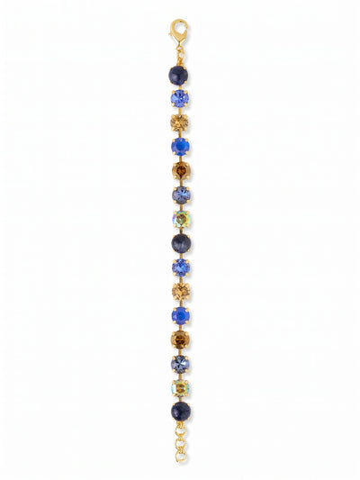Sienna Tennis Bracelet - BGA2BGDNM - <p>Deep, opaque sodalite anchors a line of sparkling crystals in shades of sapphire, smoked topaz, and iridescent aurora borealis. The kette chain construction allows each round-cut stone to articulate individually, creating a fluid movement that tracks the natural motion of your arm. The alternating mix of earthy and denim-inspired blues brings a grounded, textural feel to the classic line silhouette. An extension chain lets you adjust the length for a tailored, secure fit from morning to evening.</p><ul>
<li>Alternating opaque sodalite and faceted crystals create textural depth</li>
<li>Fluid chain construction articulates with every movement of the wrist</li>
<li>Lobster claw clasp</li>
<li>3/4-inch adjustable extension chain</li>
<li>Protective e-coat finish for lasting wear</li>
<li>Includes signature organza pouch for gifting and travel</li>
</ul>