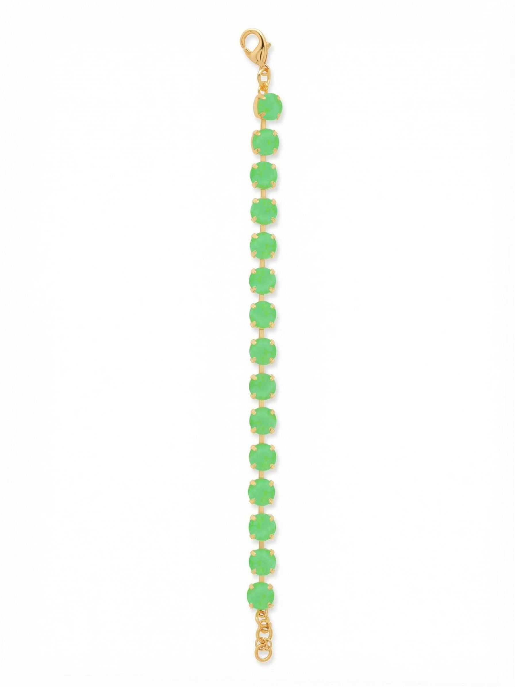 Sienna Tennis Bracelet - BGA2BGETG - <p>Fifteen round crystals in a vibrant, milky green define this classic line bracelet. The bright gold-tone settings trace the edges of each stone, giving the vivid color a structured, tailored feel. Built on a flexible kette chain, the piece moves fluidly as you go about your day. An extension chain lets you find a secure, comfortable fit whether you wear it solo or stack it with a trusted watch.</p><ul>
<li>Continuous row of large round crystals in an opaque vivid green</li>
<li>Flexible channel chain construction follows your natural movement</li>
<li>Lobster claw clasp</li>
<li>3/4-inch adjustable extension chain</li>
<li>Protective e-coat finish for lasting wear</li>
<li>Includes signature organza pouch for gifting and travel</li>
</ul>