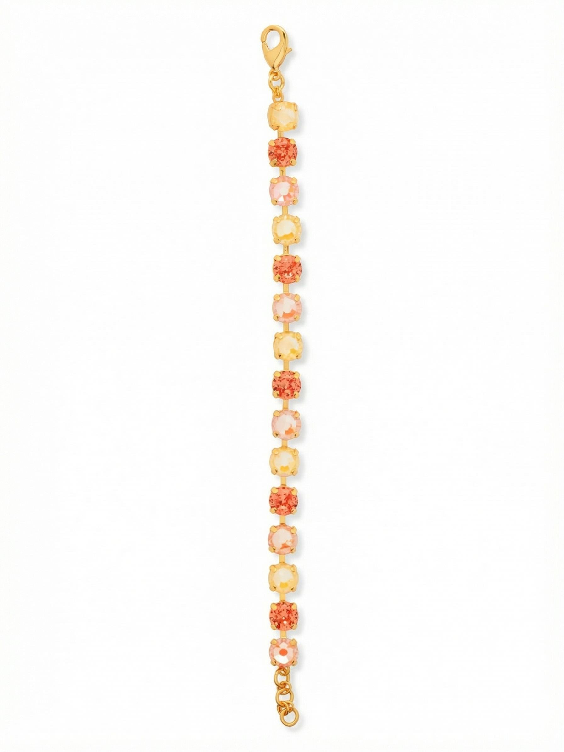 Sienna Tennis Bracelet - BGA2BGMOR - <p>Warm, sun-drenched tones define this fluid tennis bracelet. Round crystals in vibrant orange-pink, soft peach, and pale yellow line up in a repeating pattern that catches the light with every gesture. The channel-set chain allows the piece to drape comfortably and move naturally as you go about your day, offering an unbroken line of saturated color. An extension chain lets you tailor the length so it feels secure, whether worn solo or layered beside a favorite watch.</p><ul>
<li>Flexible channel-set chain ensures fluid movement</li>
<li>Repeating sequence of warm gradient round-cut crystals</li>
<li>Lobster claw clasp</li>
<li>3/4-inch adjustable extension chain</li>
<li>Protective e-coat finish for lasting wear</li>
<li>Includes signature organza pouch for gifting and travel</li>
</ul>