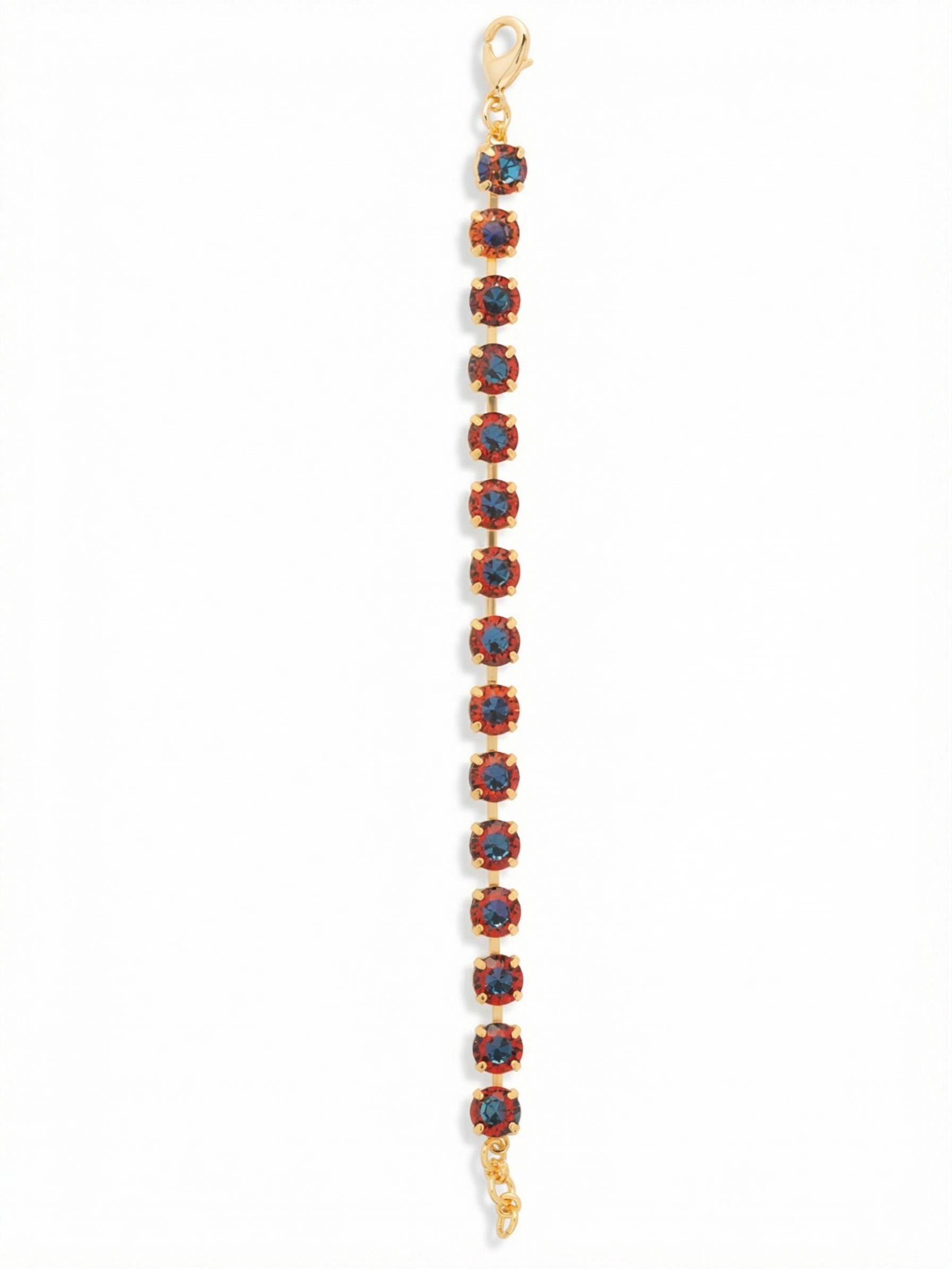 Sienna Tennis Bracelet - BGA2BGVO - <p>A single, unbroken line of large round-cut crystals captures shifting hues of deep crimson and vibrant blue with every gesture. The articulated channel chain provides a fluid drape that moves naturally with your wrist all day long. A built-in extension chain allows you to tailor the fit exactly to your preference. It is a substantial ribbon of color that easily anchors a layered stack or holds its own as a solo piece.</p><ul>
<li>Continuous line of large round-cut crystals in shifting hues</li>
<li>Flexible channel chain construction for natural fluid movement</li>
<li>Lobster claw clasp</li>
<li>3/4-inch adjustable extension chain</li>
<li>Protective e-coat finish for lasting wear</li>
<li>Includes signature organza pouch for gifting and travel</li>
</ul>