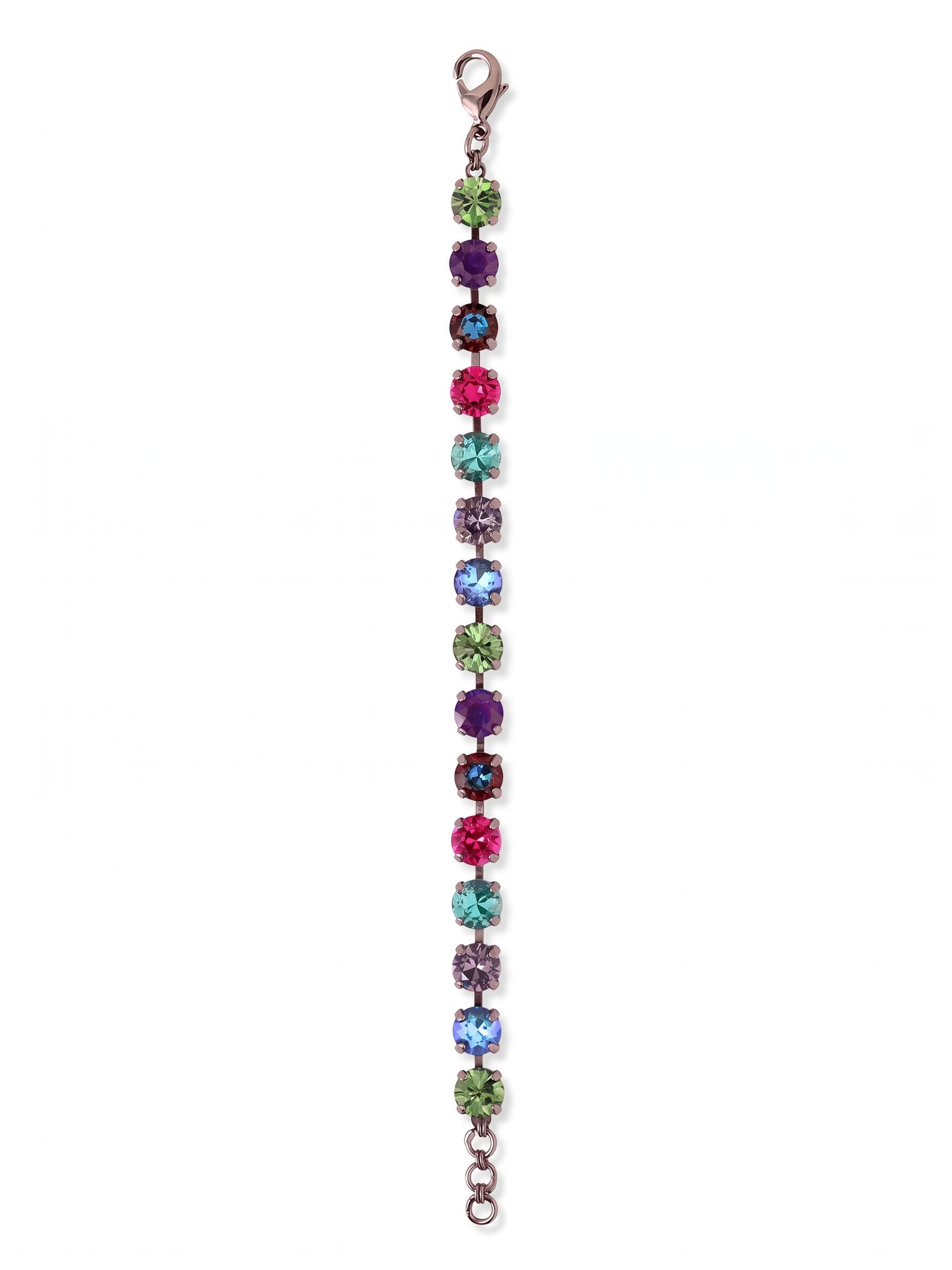 Sienna Tennis Bracelet - BGA2GMNNI - <p>An unbroken row of uniformly sized round crystals creates a flexible band of saturated color. Set in dark gunmetal, the vibrant mix of tanzanite, fuchsia, and emerald tones catches the light with every movement of your hand. The articulated chain allows the bracelet to drape naturally and follow your gestures, while an adjustable extension ensures the proper fit. It brings a concentrated streak of deep, moody color to a simple watch stack or a bare arm.</p><ul>
<li>Uniform round crystals set in a rich multi-colored sequence</li>
<li>Flexible channel construction that moves fluidly with your gestures</li>
<li>Lobster claw clasp</li>
<li>3/4-inch adjustable extension chain</li>
<li>Includes organza pouch for gifting and travel</li>
</ul>