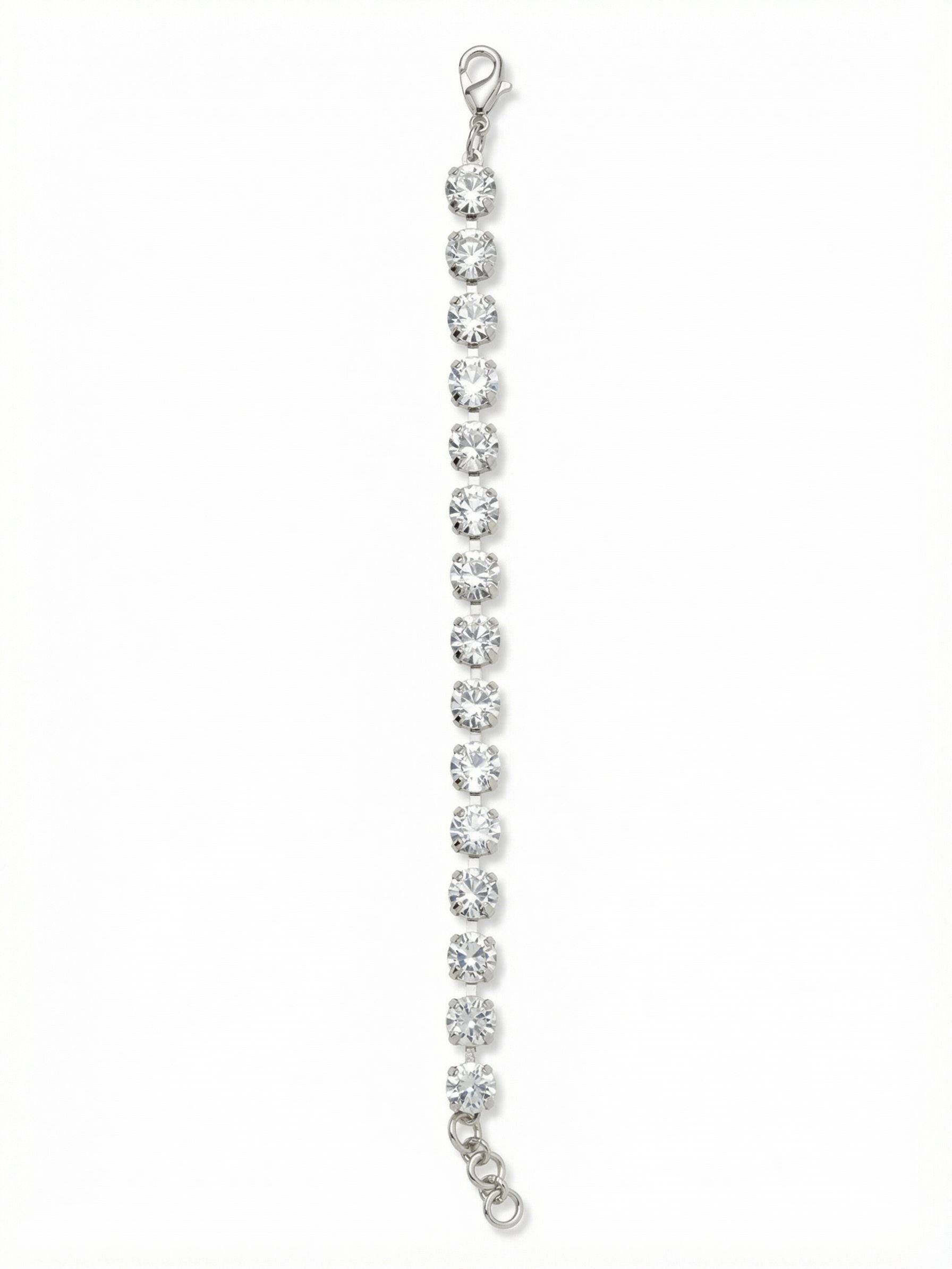 Sienna Tennis Bracelet - BGA2PDCRY - <p>A continuous line of large, round-cut clear crystals catches the light with every movement of your hand. The flexible chain construction allows this piece to drape fluidly, adapting to the natural curve of your arm. It carries enough presence to wear entirely on its own, but easily layers alongside a daily watch or heavier cuffs. An integrated extension chain lets you find the exact fit, ensuring it remains comfortable as you go about your day.</p><ul>
<li>Unbroken line of oversized round crystals in a classic tennis profile</li>
<li>Flexible channel chain construction allows fluid movement</li>
<li>Lobster claw clasp</li>
<li>3/4-inch adjustable extension chain</li>
<li>Protective e-coat finish for lasting wear</li>
<li>Includes signature organza pouch for gifting and travel</li>
</ul>