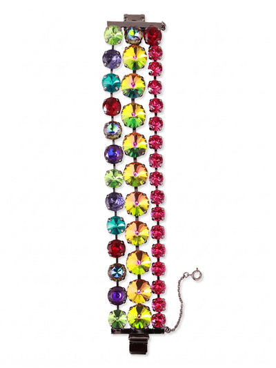 Penelope Layered Statement Bracelet - BGB4GMNNI - <p>Three parallel rows of crystals form a wide, flexible band that makes a strong visual impact without feeling stiff. A central line of oversized iridescent stones anchors the design, flanked by alternating jewel tones in slightly smaller proportions. Set in darkened metal, the highly saturated colors catch the light with every gesture. The linked construction gives the piece a satisfying weight while allowing it to move fluidly with your arm. A traditional box clasp with an attached safety chain keeps the substantial design securely in place.</p><ul>
<li>Three parallel crystal rows create a wide silhouette with a substantial feel</li>
<li>Oversized central stones anchor an alternating pattern of saturated jewel tones</li>
<li>Box clasp with secure safety chain</li>
<li>Includes organza pouch for gifting and travel</li>
</ul>