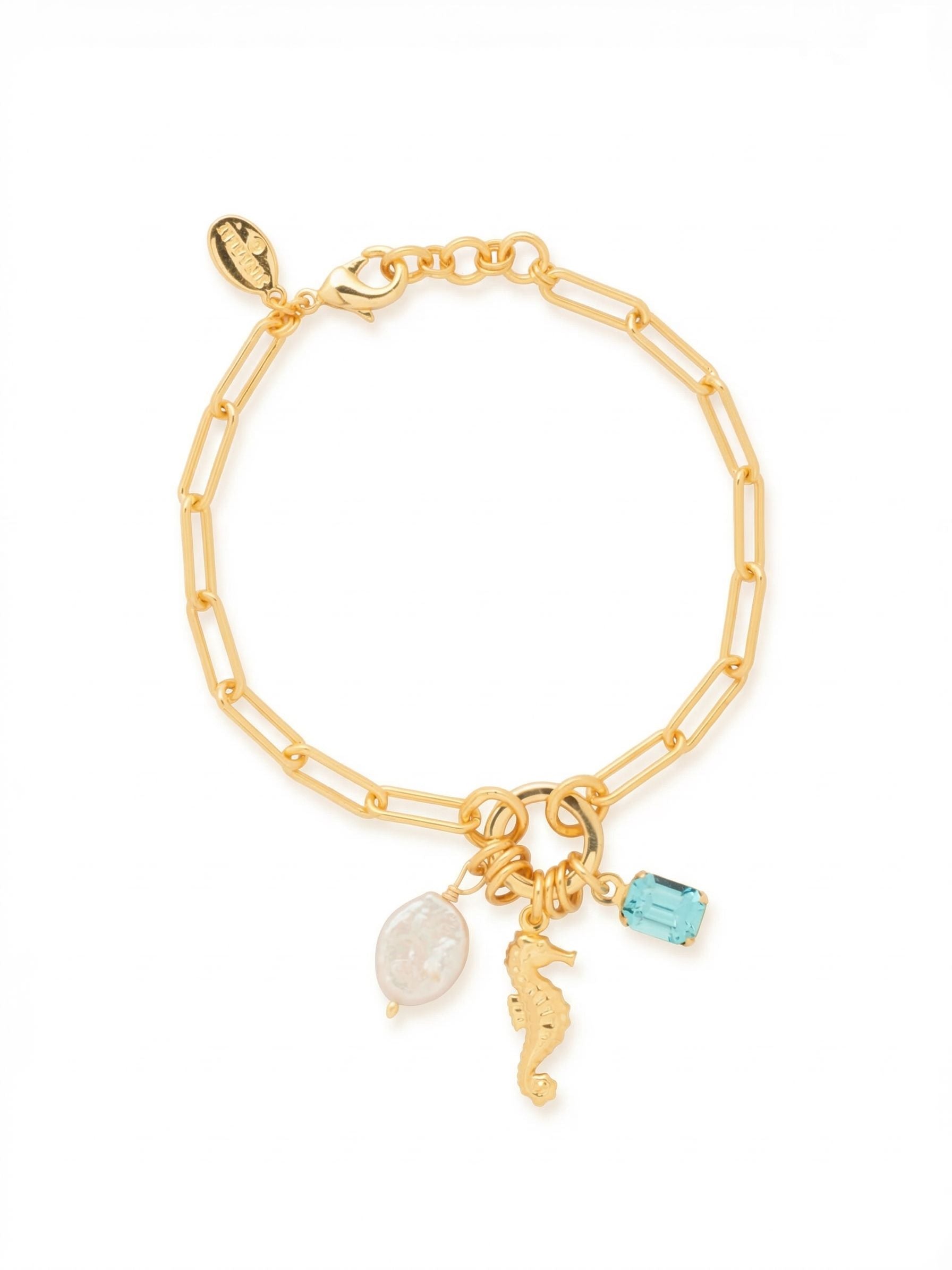 Seahorse Charm Tennis Bracelet - BGE5BGCSD - <p>An airy paperclip chain serves as a lightweight foundation for a cluster of coastal motifs. An emerald-cut aquamarine crystal catches the light, playing off the organic luster of a flat oval pearl bead and a sculpted seahorse charm. The elements gather at a central ring, allowing them to shift naturally with your wrist and create gentle movement. Designed with open links for a comfortable drape, this piece secures with an adjustable extension chain to ensure a personalized fit.</p><ul>
<li>Open-link paperclip chain creates a lightweight and airy drape</li>
<li>Central ring clusters three distinct charms for organic movement</li>
<li>Lobster claw clasp</li>
<li>3/4-inch adjustable extension chain</li>
<li>Protective e-coat finish for lasting wear</li>
<li>Includes signature organza pouch for gifting and travel</li>
</ul>