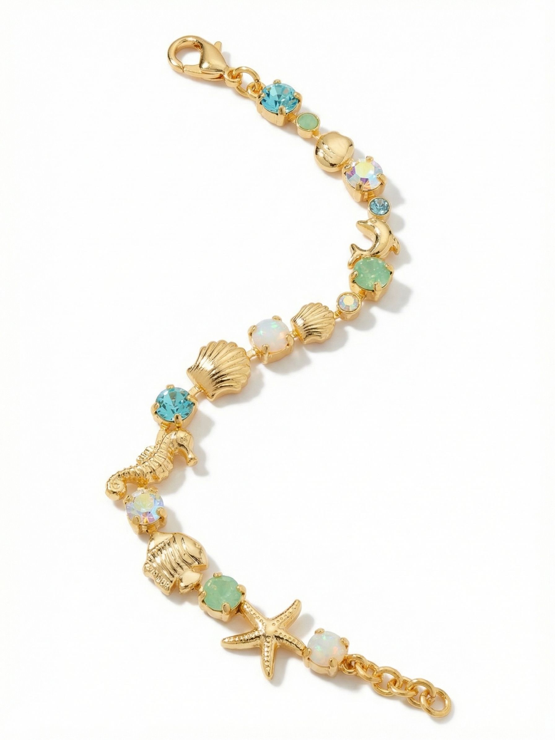 Avalon Tennis Bracelet - BGE6BGCSD - <p>Cast in warm gold tones, this playful take on the classic tennis bracelet mixes alternating aquatic crystals with sculptural sea life charms. Small details like the textured starfish and dimensional dolphin break up the crystalline line, giving the piece a tactile weight that catches the light naturally as your hand moves. The adjustable extension chain allows you to tailor the fit, letting these subtle coastal motifs bring a familiar energy to your everyday rotation.</p><ul>
<li>Alternating aquatic crystals and metallic motifs create an engaging visual rhythm</li>
<li>Sculptural sea life charms break up the classic crystal channel chain</li>
<li>Lobster claw clasp</li>
<li>3/4-inch adjustable extension chain</li>
<li>Protective e-coat finish for lasting wear</li>
<li>Includes signature organza pouch for gifting and travel</li>
</ul>