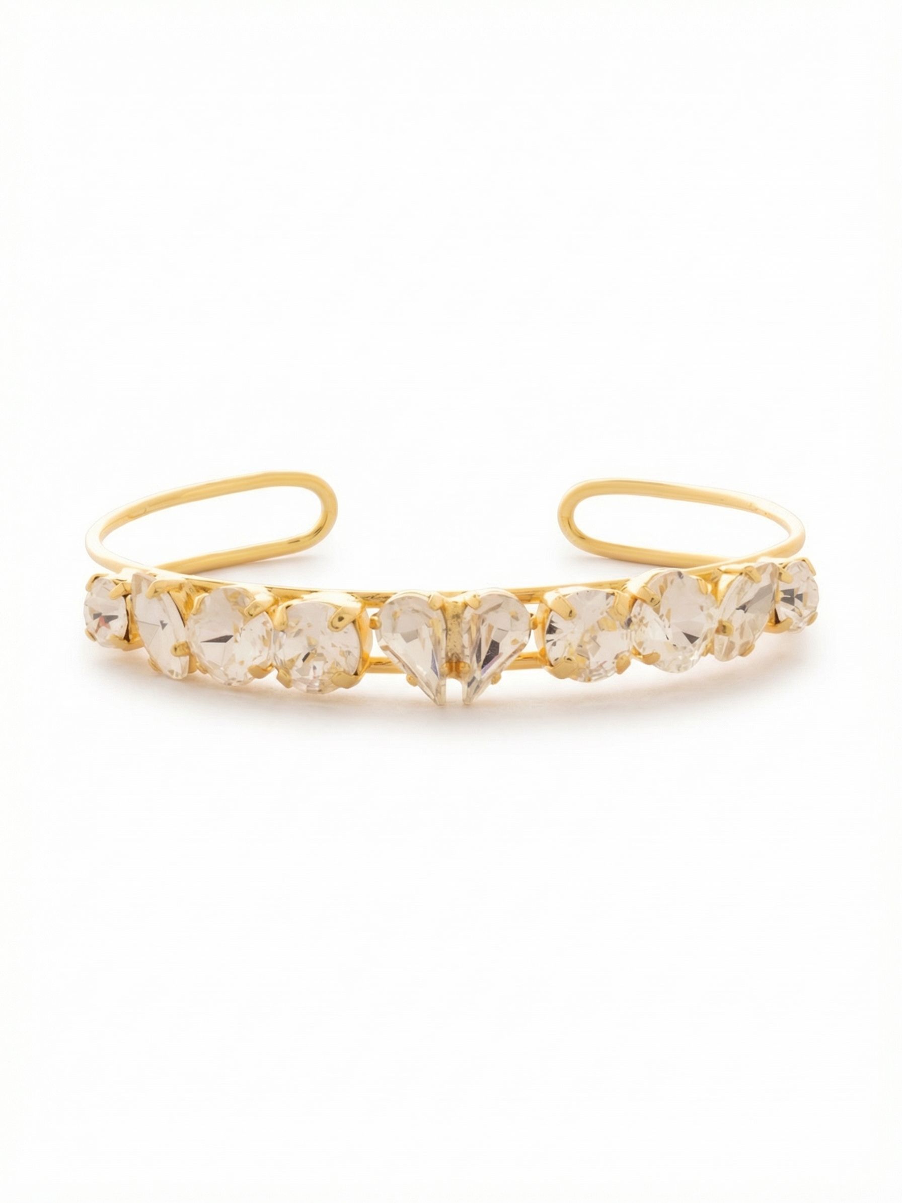 Beloved Adjustable Cuff Bracelet - BGF3BGCRY - <p>A structured piece that frames the wrist in bright metal and varied crystal shapes. Ten distinct stones trace a continuous line across the arm, anchored by center crystals that meet at a sharp angle to catch ambient light. The open looped wire band allows the cuff to slide on effortlessly and press lightly for a customized fit. It carries enough weight to wear alone, yet the airy double-band construction lets it integrate naturally into a daily stack of gold chains.</p><ul>
<li>Mixed-cut clear crystals arranged symmetrically from an angled center point</li>
<li>Open double-wire frame construction provides an airy structural feel</li>
<li>Adjustable open cuff slides on easily</li>
<li>Protective e-coat finish for lasting wear</li>
<li>Includes signature organza pouch for gifting and travel</li>
</ul>