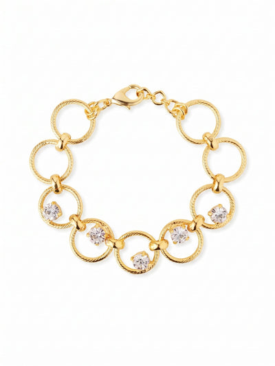 Odessa Tennis Bracelet - BGI1BGCRY - <p>A tactile take on the traditional line bracelet. Open rings of twisted metal flex fluidly with your every movement, securely joined by polished brackets. At the center of the design, five clear round-cut crystals are individually prong-set within the metalwork, creating an airy floating effect that catches light as you type or reach. The open-link construction gives this piece a generous scale without any extra weight, while an extension chain allows you to tailor the fit precisely.</p><ul>
<li>Round-cut crystals appear to float within open circular links</li>
<li>Textured rope-style metal rings offer tactile contrast</li>
<li>Lobster claw clasp</li>
<li>3/4-inch adjustable extension chain</li>
<li>Protective e-coat finish for lasting wear</li>
<li>Includes signature organza pouch for gifting and travel</li>
</ul>