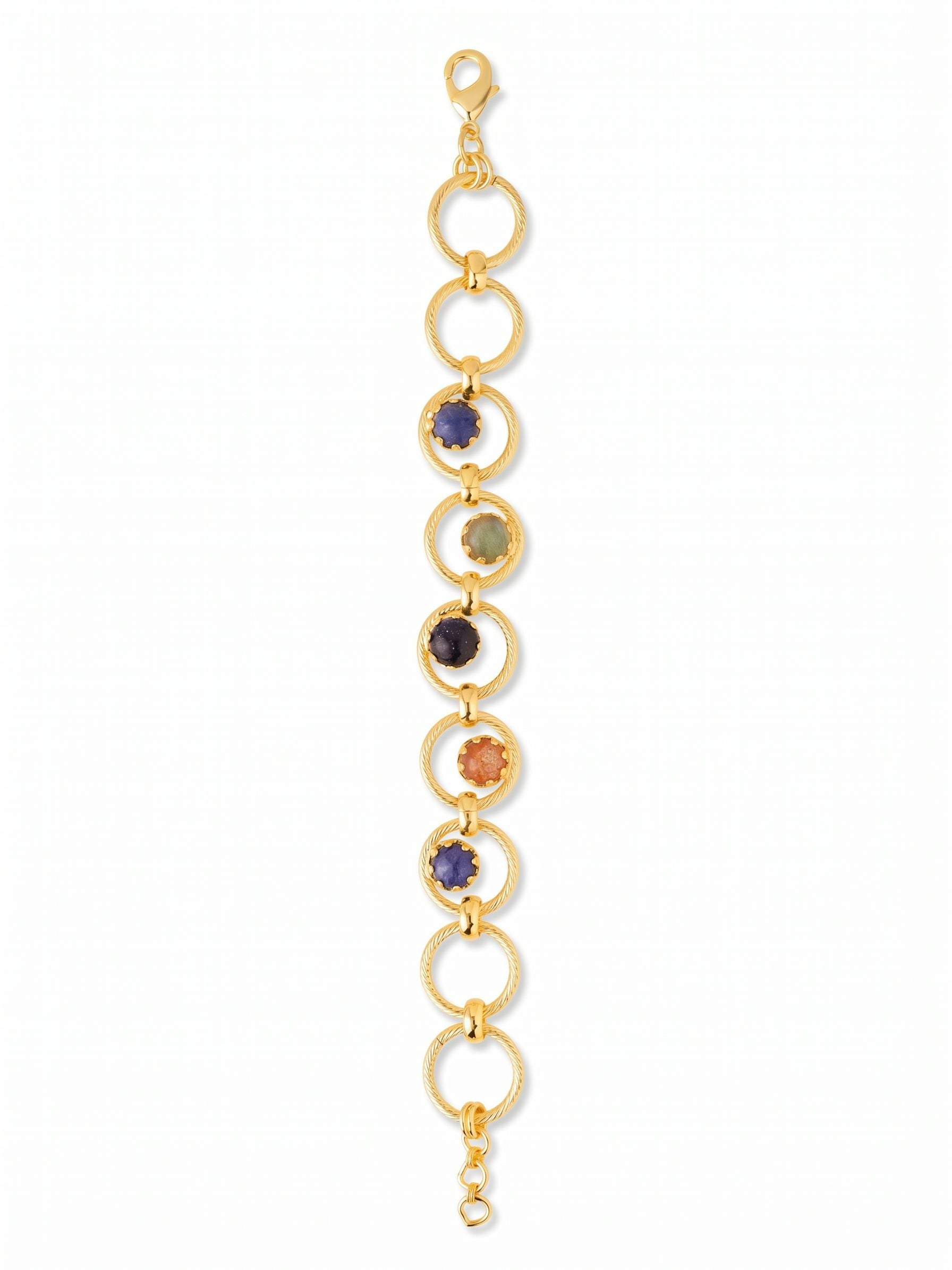 Odessa Tennis Bracelet - BGI1BGDNM - <p>Interlocking rings of textured gold-tone metal build an airy, open silhouette that moves easily with your wrist. Five central circles frame genuine stones in earthy, grounded shades, blending deep blue sodalite and goldstone with warm sunstone and luminous labradorite. Because the stones are suspended within open hoops, a glimpse of skin shows through, keeping the overall feel light and fluid. A built-in extension chain lets you dial in the exact drape you need for comfortable daily wear.</p><ul>
<li>Interlocking textured metal circles with suspended stone centers</li>
<li>Earthy mix of genuine sodalite, sunstone, and labradorite</li>
<li>Lobster claw clasp</li>
<li>3/4-inch adjustable extension chain</li>
<li>Protective e-coat finish for lasting wear</li>
<li>Includes organza pouch for gifting and travel</li>
</ul>