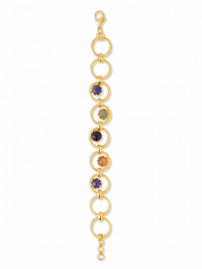 Odessa Tennis Bracelet - BGI1BGDNM - <p>Interlocking rings of textured gold-tone metal build an airy, open silhouette that moves easily with your wrist. Five central circles frame genuine stones in earthy, grounded shades, blending deep blue sodalite and goldstone with warm sunstone and luminous labradorite. Because the stones are suspended within open hoops, a glimpse of skin shows through, keeping the overall feel light and fluid. A built-in extension chain lets you dial in the exact drape you need for comfortable daily wear.</p><ul>
<li>Interlocking textured metal circles with suspended stone centers</li>
<li>Earthy mix of genuine sodalite, sunstone, and labradorite</li>
<li>Lobster claw clasp</li>
<li>3/4-inch adjustable extension chain</li>
<li>Protective e-coat finish for lasting wear</li>
<li>Includes organza pouch for gifting and travel</li>
</ul>