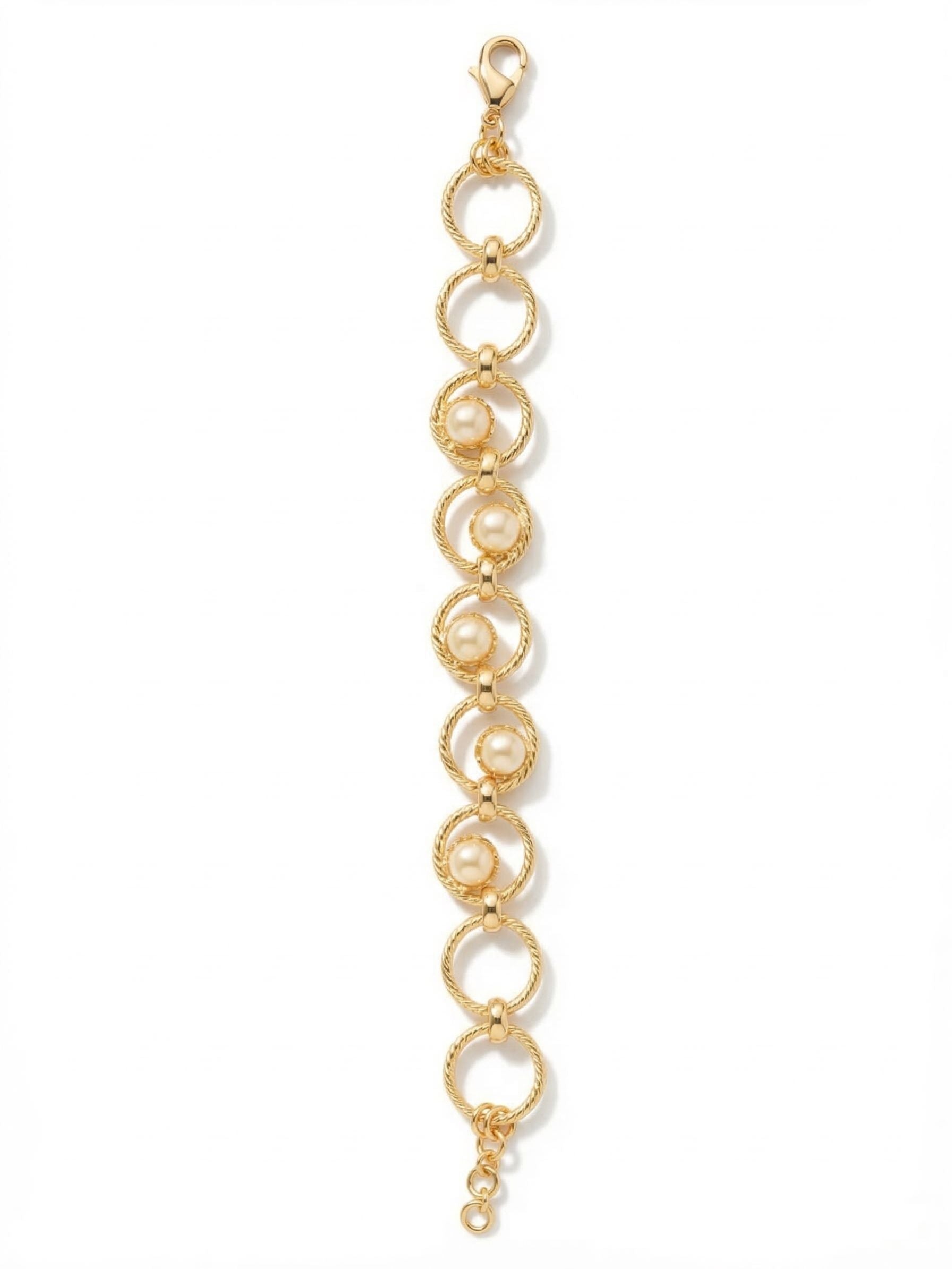 Odessa Tennis Bracelet - BGI1BGMDP - <p>Textured gold-tone rings interlock to form an open, airy chain. Five round white pearls nestle within the center links, offering a modern geometry that rethinks the classic pearl bracelet. The twisted rope texture of the metal catches the light, while the open framework keeps the piece lightweight and fluid in motion. An adjustable extension chain ensures it drapes exactly where you want it, making it an easy companion for daily wear or layered beside a heavier cuff.</p><ul>
<li>Twisted rope metalwork contrasts with the smooth organic luster of pearls</li>
<li>Open ring construction provides a lightweight and fluid drape</li>
<li>Lobster claw clasp</li>
<li>3/4-inch adjustable extension chain</li>
<li>Protective e-coat finish for lasting wear</li>
<li>Includes signature organza pouch for gifting and travel</li>
</ul>