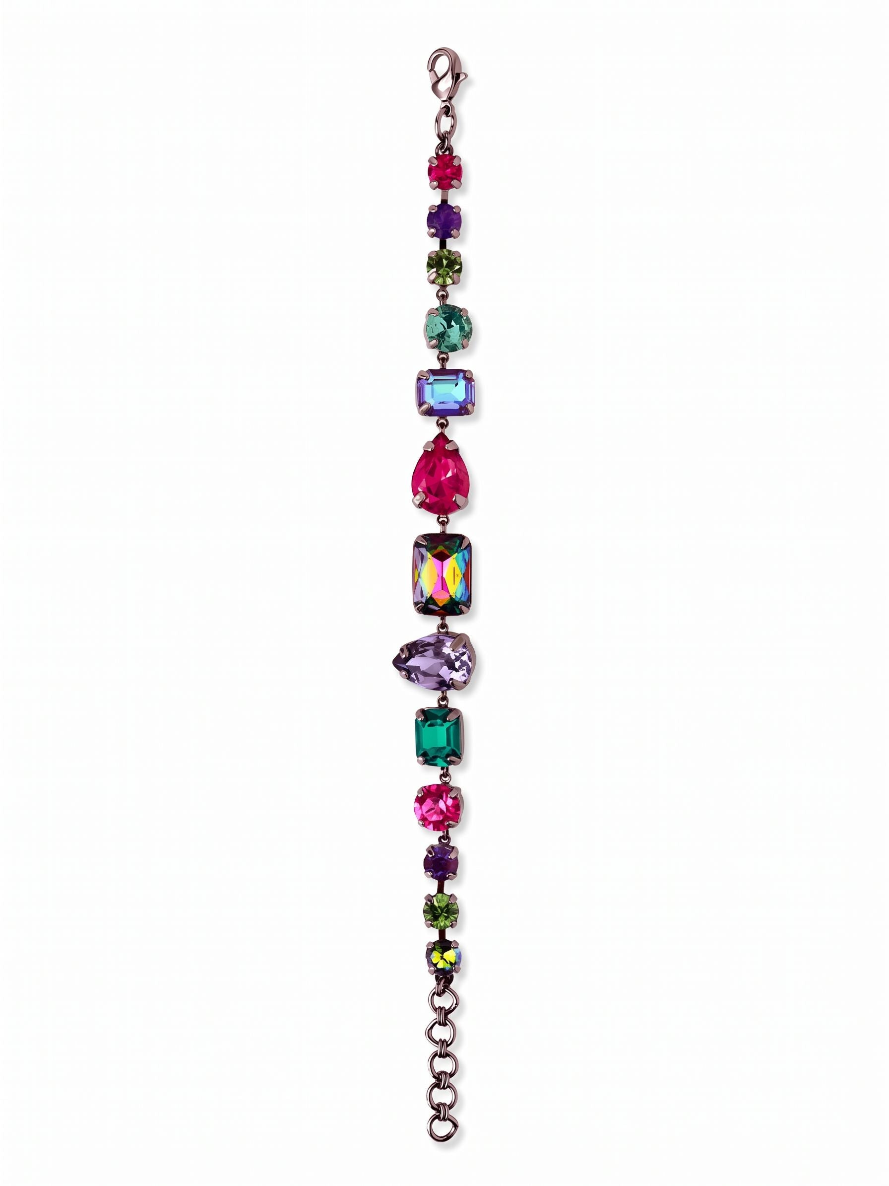 Moxie Tennis Bracelet - BGI30GMNNI - <p>This tennis bracelet breaks from tradition with a lineup of mixed cuts and vibrant jewel tones. Pear, emerald, and round crystals in deep fuchsia, blue zircon, and tanzanite contrast sharply against the dark gunmetal setting. The flexible chain construction gives the piece fluid movement, catching light from multiple angles as your hands move. It brings a grounded pop of color to a simple dark sleeve and includes an extension chain so you can adjust the drape exactly how you prefer.</p><ul>
<li>Eclectic sequence of pear, emerald, and round crystal cuts</li>
<li>Fluid chain construction for natural movement</li>
<li>Lobster claw clasp</li>
<li>3/4-inch adjustable extension chain</li>
<li>Includes signature organza pouch for gifting and travel</li>
</ul>