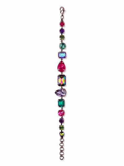 Moxie Tennis Bracelet - BGI30GMNNI - <p>This tennis bracelet breaks from tradition with a lineup of mixed cuts and vibrant jewel tones. Pear, emerald, and round crystals in deep fuchsia, blue zircon, and tanzanite contrast sharply against the dark gunmetal setting. The flexible chain construction gives the piece fluid movement, catching light from multiple angles as your hands move. It brings a grounded pop of color to a simple dark sleeve and includes an extension chain so you can adjust the drape exactly how you prefer.</p><ul>
<li>Eclectic sequence of pear, emerald, and round crystal cuts</li>
<li>Fluid chain construction for natural movement</li>
<li>Lobster claw clasp</li>
<li>3/4-inch adjustable extension chain</li>
<li>Includes signature organza pouch for gifting and travel</li>
</ul>