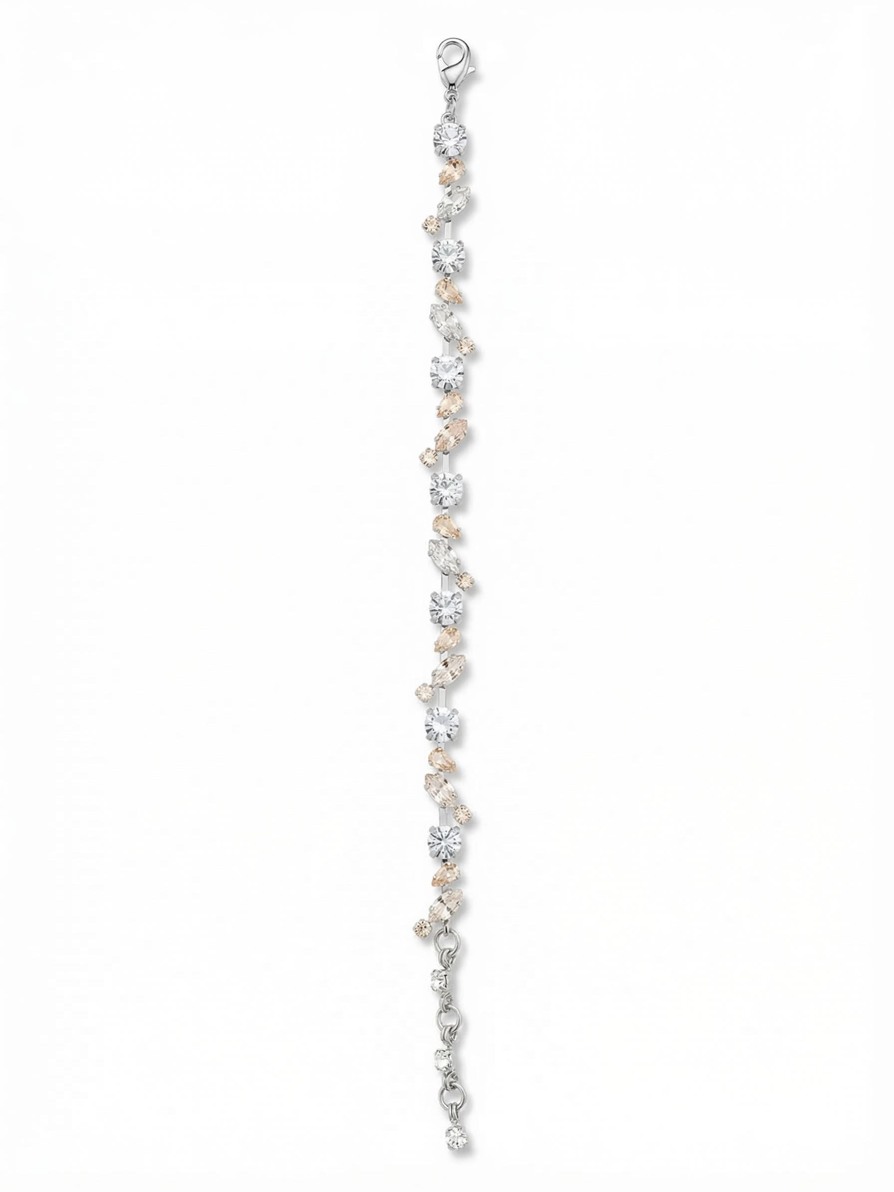 Daphne Tennis Bracelet - BGJ2PDCLA - <p>A delicate shift from the traditional straight-line design. The Daphne scatters round, marquise, and pear-cut crystals along a fine channel chain, creating an intricate vine-like rhythm. White opal and warm silk tones soften the bright clear crystals, bringing a quiet vintage feel that catches the light with every movement of your hand. A four-inch extension chain lets you secure a precise, comfortable drape that stays completely out of your way throughout the day.</p><ul>
<li>Asymmetric scattering of pear, marquise, and round crystals</li>
<li>Delicate crystal-set channel chain provides fluid movement</li>
<li>Lobster claw clasp</li>
<li>Protective e-coat finish for lasting wear</li>
<li>Includes signature organza pouch for gifting and travel</li>
</ul>