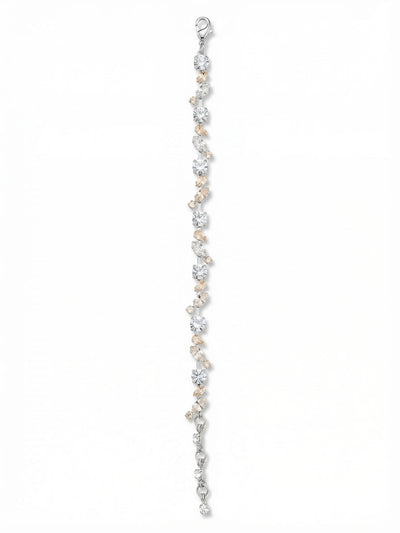Daphne Tennis Bracelet - BGJ2PDCLA - <p>A delicate shift from the traditional straight-line design. The Daphne scatters round, marquise, and pear-cut crystals along a fine channel chain, creating an intricate vine-like rhythm. White opal and warm silk tones soften the bright clear crystals, bringing a quiet vintage feel that catches the light with every movement of your hand. A four-inch extension chain lets you secure a precise, comfortable drape that stays completely out of your way throughout the day.</p><ul>
<li>Asymmetric scattering of pear, marquise, and round crystals</li>
<li>Delicate crystal-set channel chain provides fluid movement</li>
<li>Lobster claw clasp</li>
<li>Protective e-coat finish for lasting wear</li>
<li>Includes signature organza pouch for gifting and travel</li>
</ul>