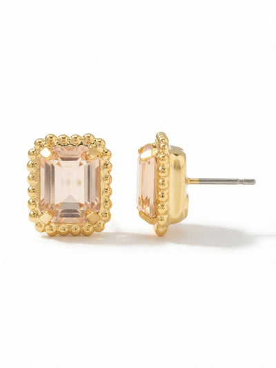 Octavia Scalloped Stud Earrings - EBW18BGGNS - <p>An emerald-cut crystal framed by a delicate beaded metal edge gives this stud earring a structured warmth. The pale champagne tone catches the light subtly at conversation distance, offering a quiet glow rather than a bright flash. Measuring half an inch long, it holds a definitive presence on the ear without feeling heavy. An oversized comfort clutch back keeps the setting secure and perfectly angled from morning meetings through evening plans.</p><ul>
<li>Beaded metal edge outlining a single emerald-cut crystal</li>
<li>Tailored rectangular profile with warm tonal depth</li>
<li>Post with oversized comfort-clutch back</li>
<li>Protective e-coat finish for lasting wear</li>
<li>Includes signature organza pouch for gifting and travel</li>
</ul>