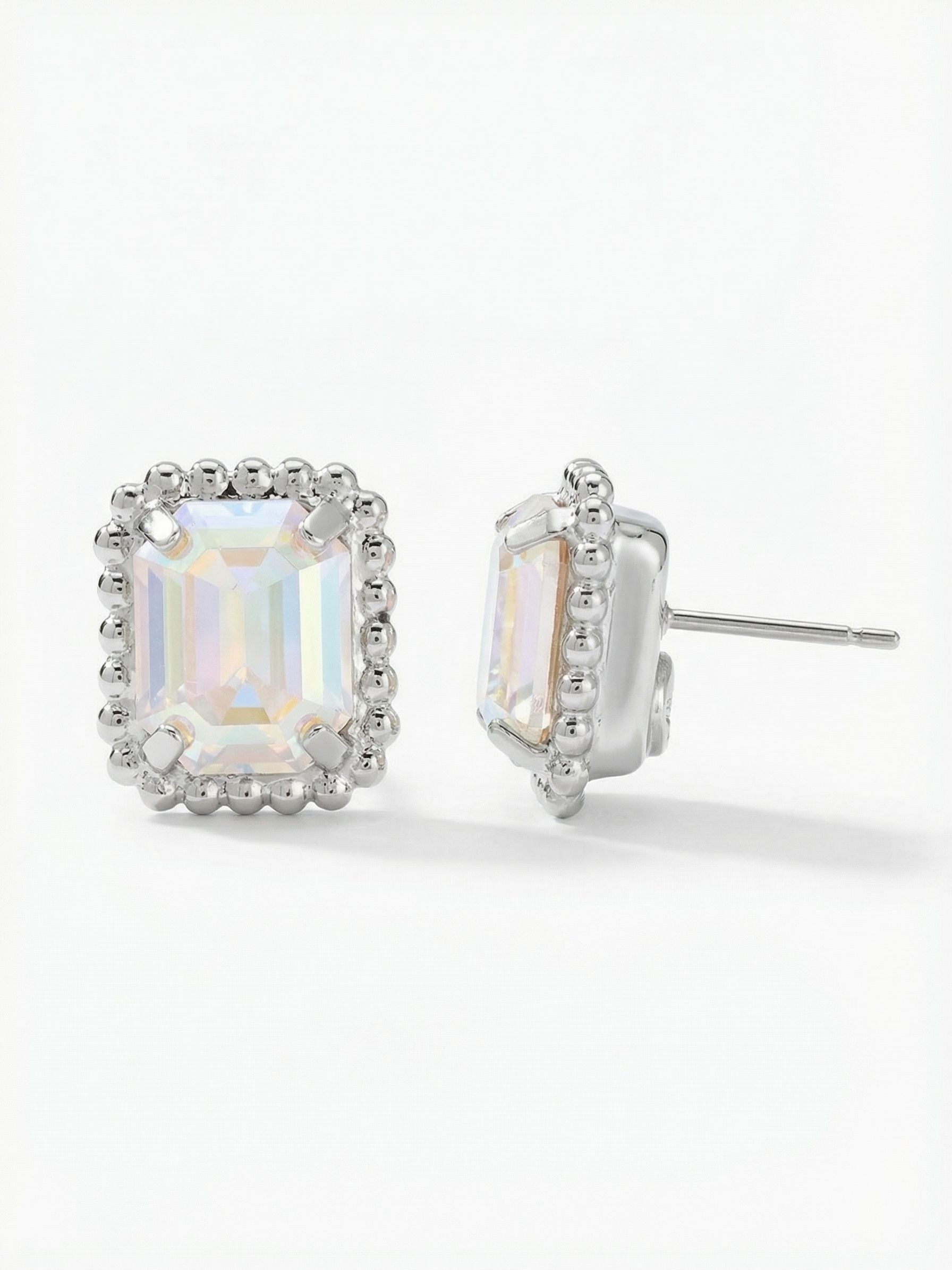 Octavia Scalloped Stud Earrings - EBW18PDCAB - <p>A single emerald-cut crystal throws broad flashes of iridescent light from the center of this architectural stud. Framed by a textured ball chain edge, the rectangular shape provides a clean, tailored geometry that reads clearly from across a table. Measuring a half-inch long, this piece brings substantial presence to your daily rotation. An oversized pressure-fit comfort back keeps the weight perfectly balanced, ensuring the crystal sits flush against the ear without drooping.</p><ul>
<li>Emerald-cut crystal offers broad flashes of iridescent color</li>
<li>Textured ball chain edge provides architectural framing</li>
<li>Post with oversized comfort-clutch back</li>
<li>Protective e-coat finish for lasting wear</li>
<li>Includes signature organza pouch for gifting and travel</li>
</ul>