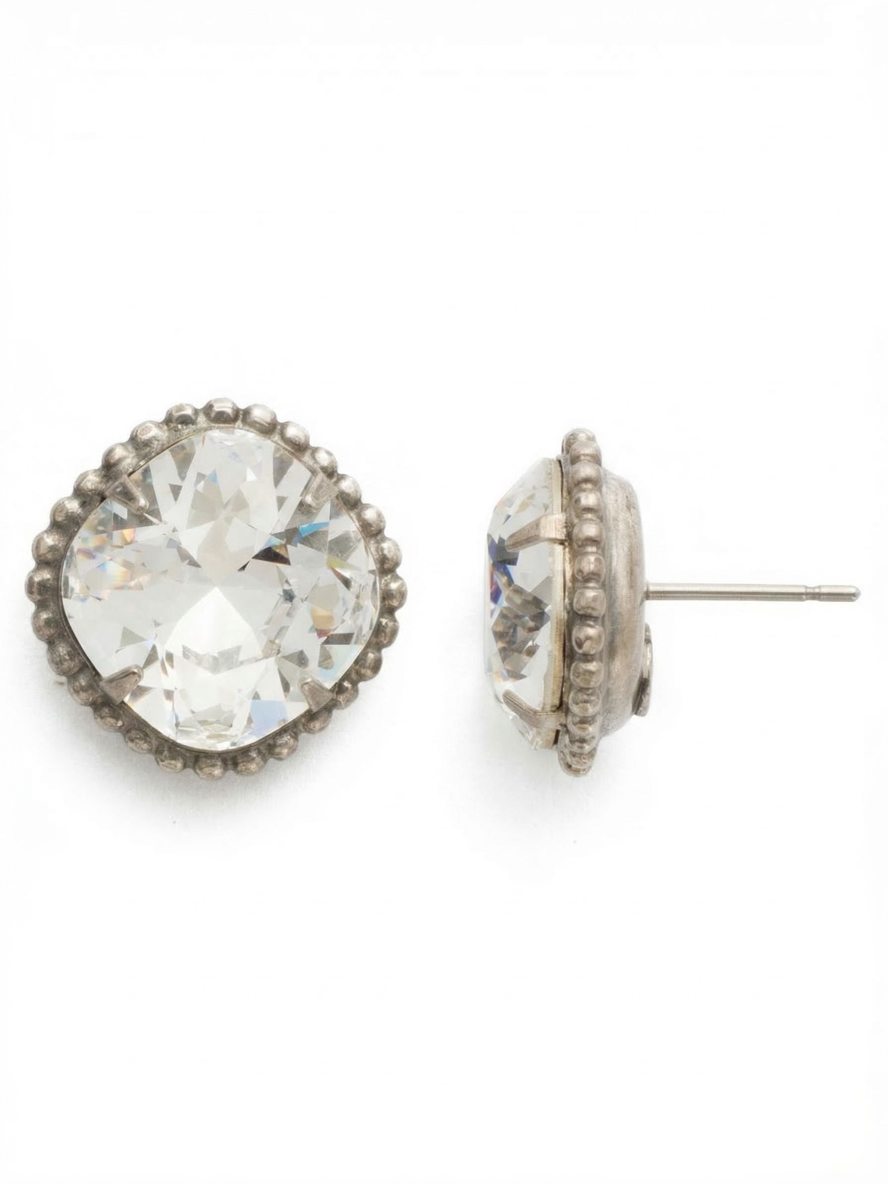 Cushion-Cut Solitaire Stud Earrings - EBX10ASCRY - <p>A substantial solitaire with quiet vintage appeal. A single, large cushion-cut crystal is framed by a finely detailed ball chain border, grounding the bright faceting with textured metal. Measuring over half an inch across, this stud delivers significant visual presence. Because larger stones need proper support, we include an oversized comfort back to keep the piece lifted, secure, and perfectly positioned throughout your day.</p><ul>
<li>Oversized 12mm cushion-cut center crystal</li>
<li>Framed by a detailed ball chain border</li>
<li>Post with oversized comfort-clutch back</li>
<li>Includes signature organza pouch for gifting and travel</li>
</ul>