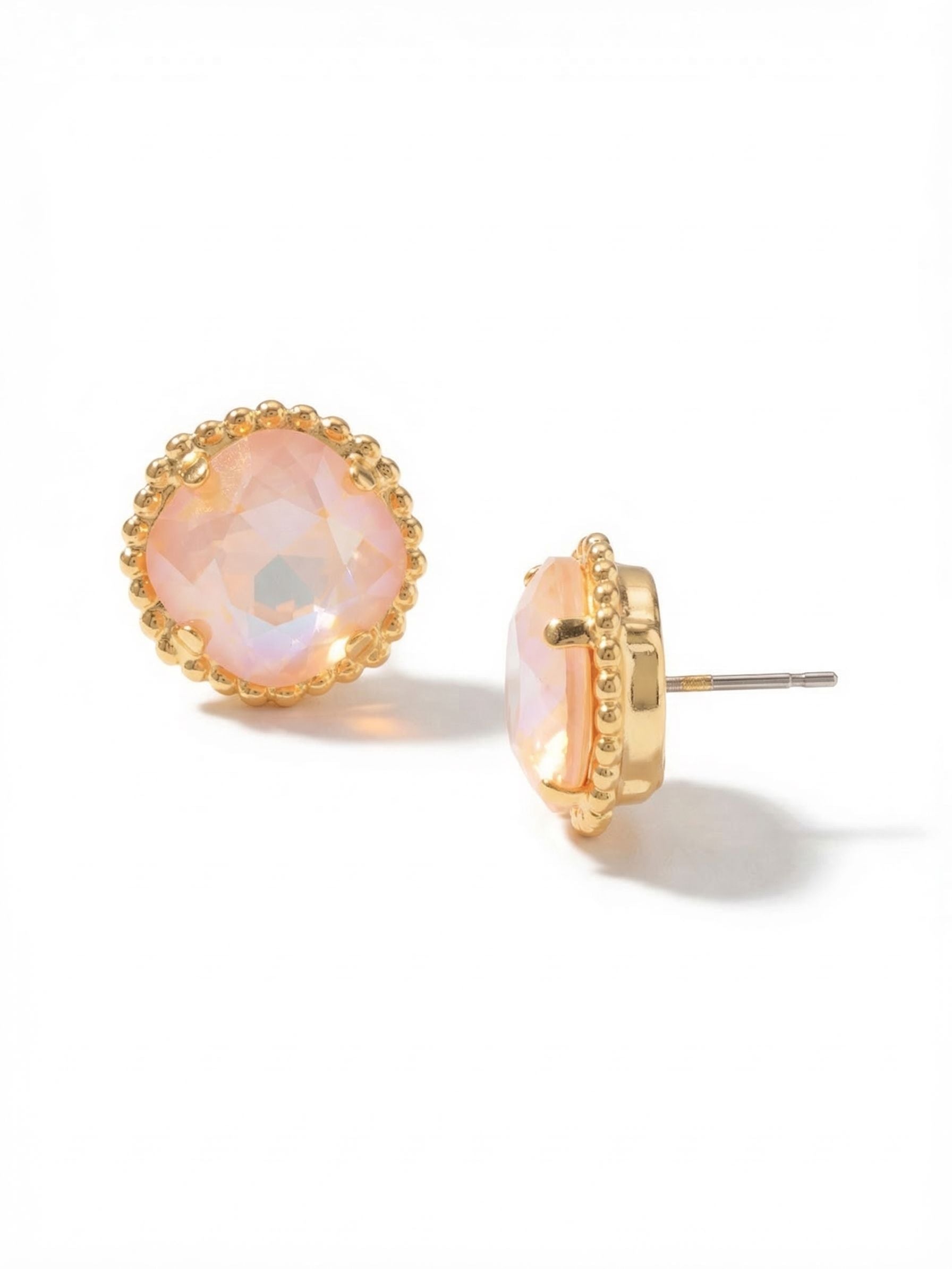 Cushion-Cut Solitaire Stud Earrings - EBX10BGPD - <p>A substantial twelve-millimeter cushion-cut crystal anchors this softly iridescent peach stud. The setting is framed by a delicate beaded texture that adds a subtle crafted detail to the profile. Measuring over half an inch across, these earrings offer a commanding presence at conversation distance while remaining light enough for daily wear. An oversized comfort clutch back ensures the broad design sits securely and upright, keeping the faceted face perfectly positioned as you move through your routine.</p><ul>
<li>Subtle beaded texture framing a prominent twelve-millimeter center crystal</li>
<li>Broad face design that catches light at conversation distance</li>
<li>Post with oversized comfort-clutch back</li>
<li>Protective e-coat finish for lasting wear</li>
<li>Includes signature organza pouch for gifting and travel</li>
</ul>