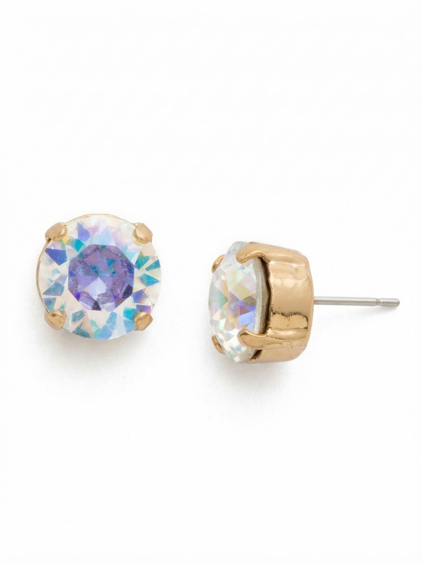 London Stud Earrings - ECM14BGCAB - <p>A classic solitary stud scaled up for clear visibility. Measuring a half inch across, these round crystals flash iridescent shifts of violet, blue, and gold as you turn your head. The deep, four-prong setting gives the profile a substantial presence, while an oversized comfort clutch holds the weight perfectly upright all day.</p><ul>
<li>Oversized solitary crystal with distinct prismatic color shifts</li>
<li>Substantial depth from the deep four-prong basket setting</li>
<li>Post with oversized comfort-clutch back</li>
<li>Protective e-coat finish for lasting wear</li>
<li>Includes signature organza pouch for gifting and travel</li>
</ul>