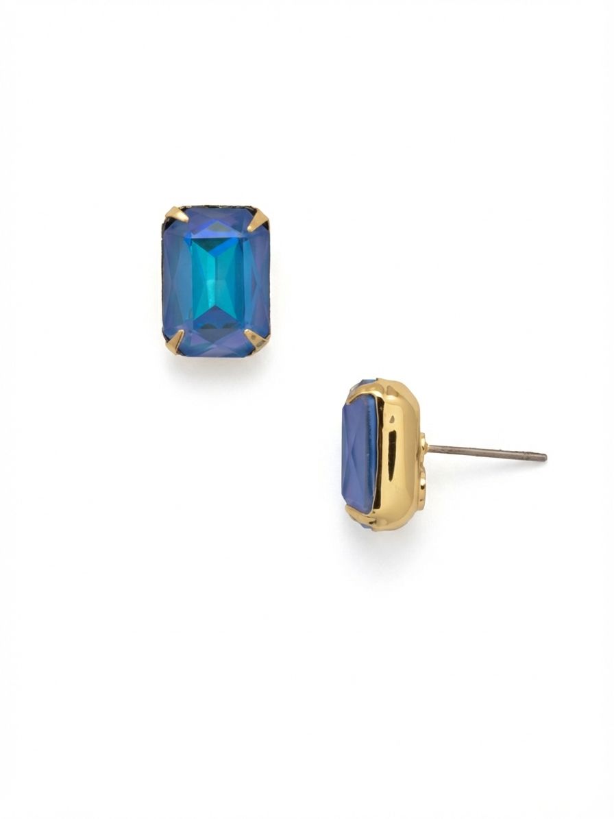 Everyday Stud Earrings - ECT11BGOCD - <p>A single emerald-cut crystal anchors this stud, offering structured planes of color that shift in the light. The bright gold setting provides a clean, solid frame around the stone, giving it a modern weight. At over half an inch long, this piece has enough scale to read clearly from across a room. An oversized comfort clutch keeps the stone sitting upright and secure all day, preventing it from tipping forward.</p><ul>
<li>Clean planes of an emerald-cut crystal offer structured light reflection</li>
<li>Substantial metal setting frames the stone with a sleek border</li>
<li>Post with oversized comfort-clutch back</li>
<li>Protective e-coat finish for lasting wear</li>
<li>Includes signature organza pouch for gifting and travel</li>
</ul>