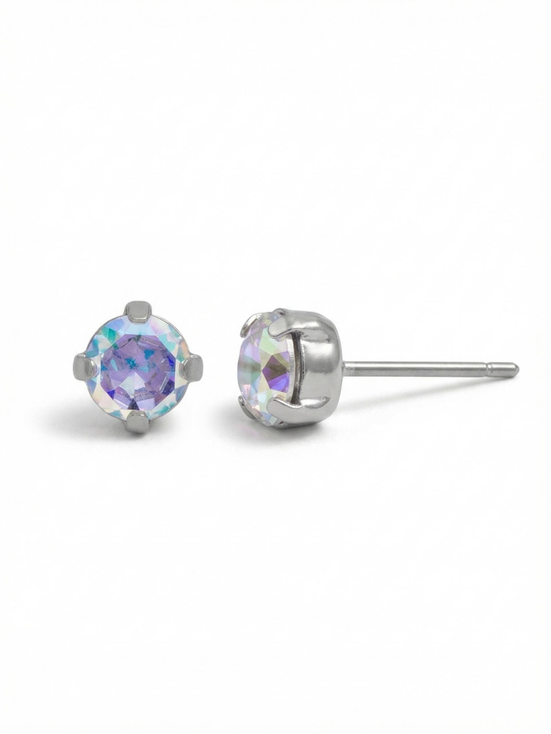 Jayda Stud Earrings - EDN32PDCAB - <p>A solitary round crystal catches the light with shifting iridescent color. Measuring just a quarter inch across, this classic four-prong setting brings a subtle but vivid detail to your daily routine. The cool tone of the setting frames the faceted stones cleanly. An oversized comfort clutch backing ensures a secure, balanced fit from morning until night.</p><ul>
<li>Classic solitary round crystal silhouette</li>
<li>Iridescent facets shift between warm and cool tones in the light</li>
<li>Post with oversized comfort-clutch back</li>
<li>Protective e-coat finish for lasting wear</li>
<li>Includes signature organza pouch for gifting and travel</li>
</ul>