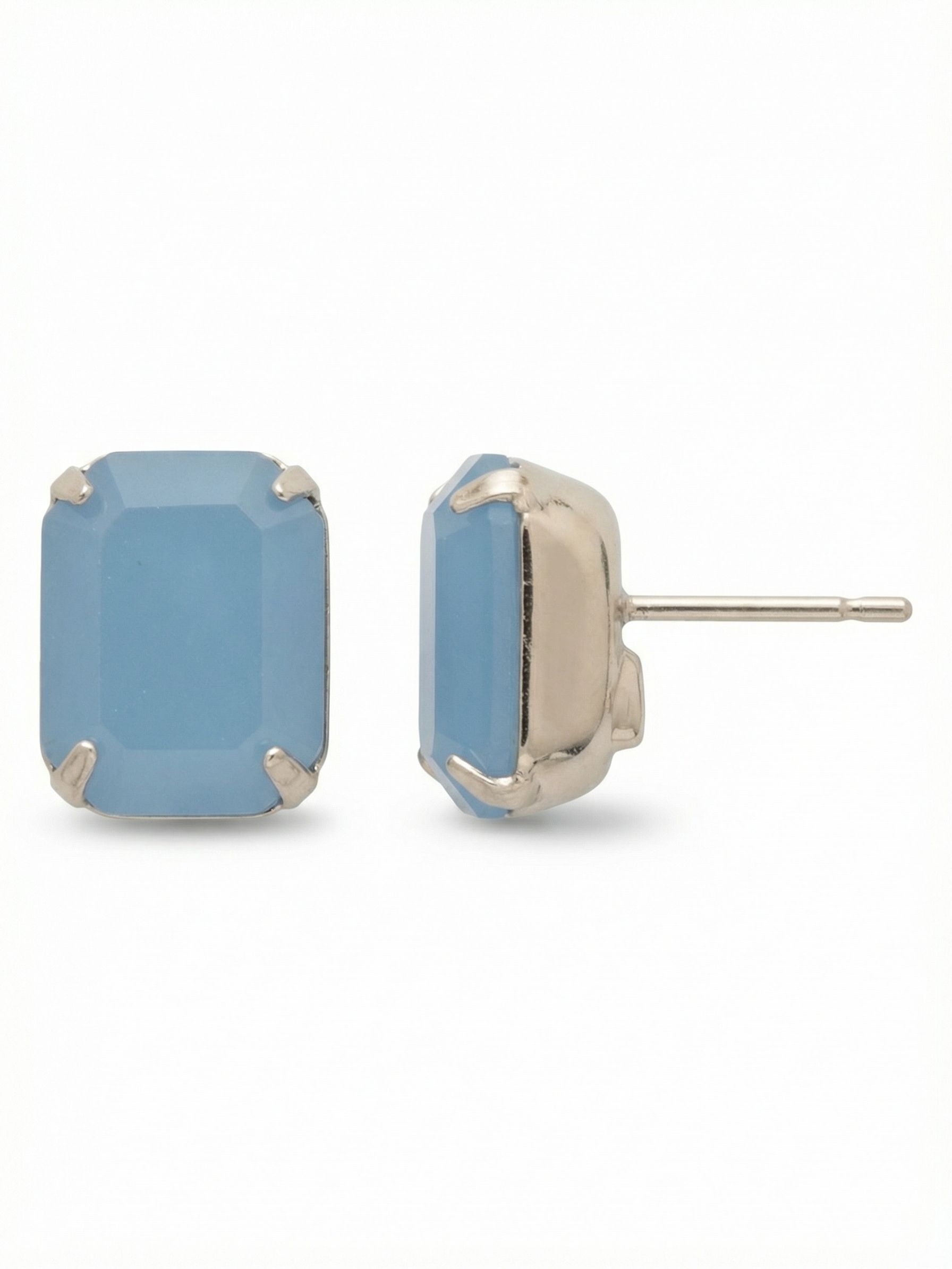 Octavia Stud Earrings - EDU53PDABO - <p>A single emerald-cut crystal anchors this substantial stud, offering a clean, geometric presence that reads clearly from across a room. The soft, clouded blue of the stone catches light with quiet intent, framed simply by the bright setting. Because of the noticeable scale, these earrings include oversized comfort clutches that keep the weight balanced and secure. They stay positioned flush against the ear all day, bringing a grounded touch of color to your daily routine.</p><ul>
<li>Single oversized emerald-cut crystal creates a clean architectural profile</li>
<li>Substantial stone size reads clearly at conversation distance</li>
<li>Post with oversized comfort-clutch back</li>
<li>Protective e-coat finish for lasting wear</li>
<li>Includes signature organza pouch for gifting and travel</li>
</ul>