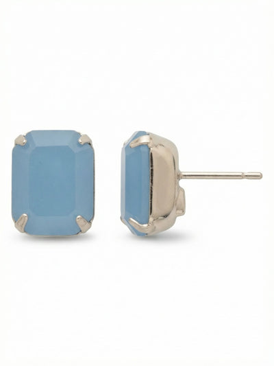 Octavia Stud Earrings - EDU53PDABO - <p>A single emerald-cut crystal anchors this substantial stud, offering a clean, geometric presence that reads clearly from across a room. The soft, clouded blue of the stone catches light with quiet intent, framed simply by the bright setting. Because of the noticeable scale, these earrings include oversized comfort clutches that keep the weight balanced and secure. They stay positioned flush against the ear all day, bringing a grounded touch of color to your daily routine.</p><ul>
<li>Single oversized emerald-cut crystal creates a clean architectural profile</li>
<li>Substantial stone size reads clearly at conversation distance</li>
<li>Post with oversized comfort-clutch back</li>
<li>Protective e-coat finish for lasting wear</li>
<li>Includes signature organza pouch for gifting and travel</li>
</ul>